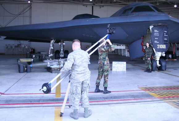 WHITEMAN AIR FORCE BASE, Mo. - Senior Airman John – David Schondelmeyer and Staff Sgt. Stephen Teel, 509th Bomb Wing Public Affairs, capture broadcast footage of Staff Sgt. Robert Smith, 509th Aircraft Maintenance Squadron, during the making of an upcoming video production Jan. 28. (U.S. Air Force photo/Airman 1st Class Stephen Linch) 