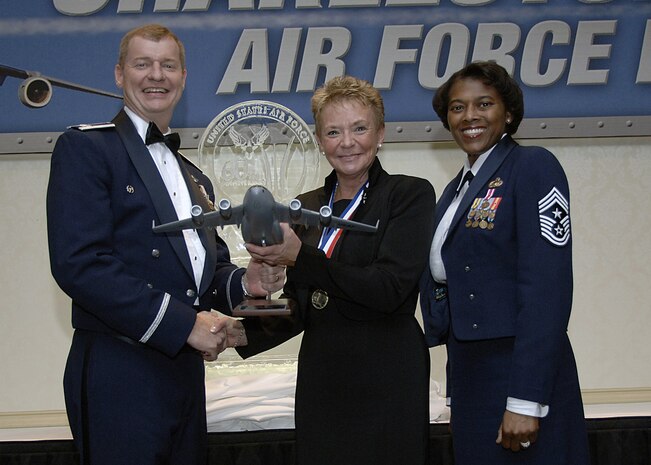 Col. John "Red" Millander, 437th Airlift Wing commander, and Chief Master Sgt. Bernice Belcer, 437th Airlift Wing command chief master sergeant, present the Community Volunteer of the Year award to Dottie Karst, a member of the Honorary Advisory Council, at the 437 AW Annual Awards Dinner at the 437 AW Annual Awards dinner at the Charleston Club Jan. 24. (U.S. Air Force photo/Airman 1st Class Katie Gieratz)