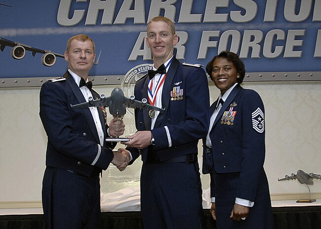Col. John "Red" Millander, 437th Airlift Wing commander, and Chief Master Sgt. Bernice Belcer, 437th Airlift Wing command chief master sergeant, present the Senior Company grade Officer of the Year award to Capt. Samuel Todd, 14th Airlift Squadron, at the 437 AW Annual Awards dinner at the Charleston Club Jan. 24. (U.S. Air Force photo/Airman 1st Class Katie Gieratz)