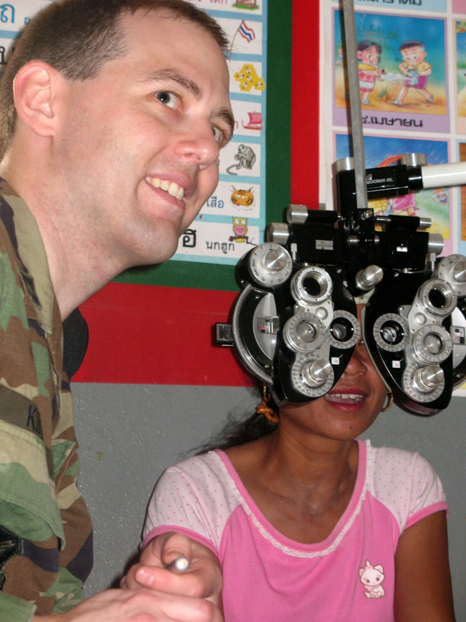Capt. Wesley Kinerk treats Sumnieng Jomgaklang Jan. 29 at Ban Don Phawa School in a rural community outside of Korat, Thailand. Captain Kinerk, an optometrist from Misawa Air Base, Japan, is part of a medical team from Pacific Air Forces that's providing dental and medical care to Thais in the rural Korat areas during Exercise Cope Tiger. The exercise is a multilateral joint and combined field training and humanitarian and civic assistance exercise involving Thailand, Singapore and the United States. The Thai-, Singaporean- and U.S.-hosted exercise enhances combined readiness and interoperability, reinforces U.S. commitment to the Southeast Asian region, and demonstrates U.S. capability to project combined and joint forces strategically in a multilateral environment. (U.S. Navy photo/Petty Officer 3rd Class AC Rainey) 

