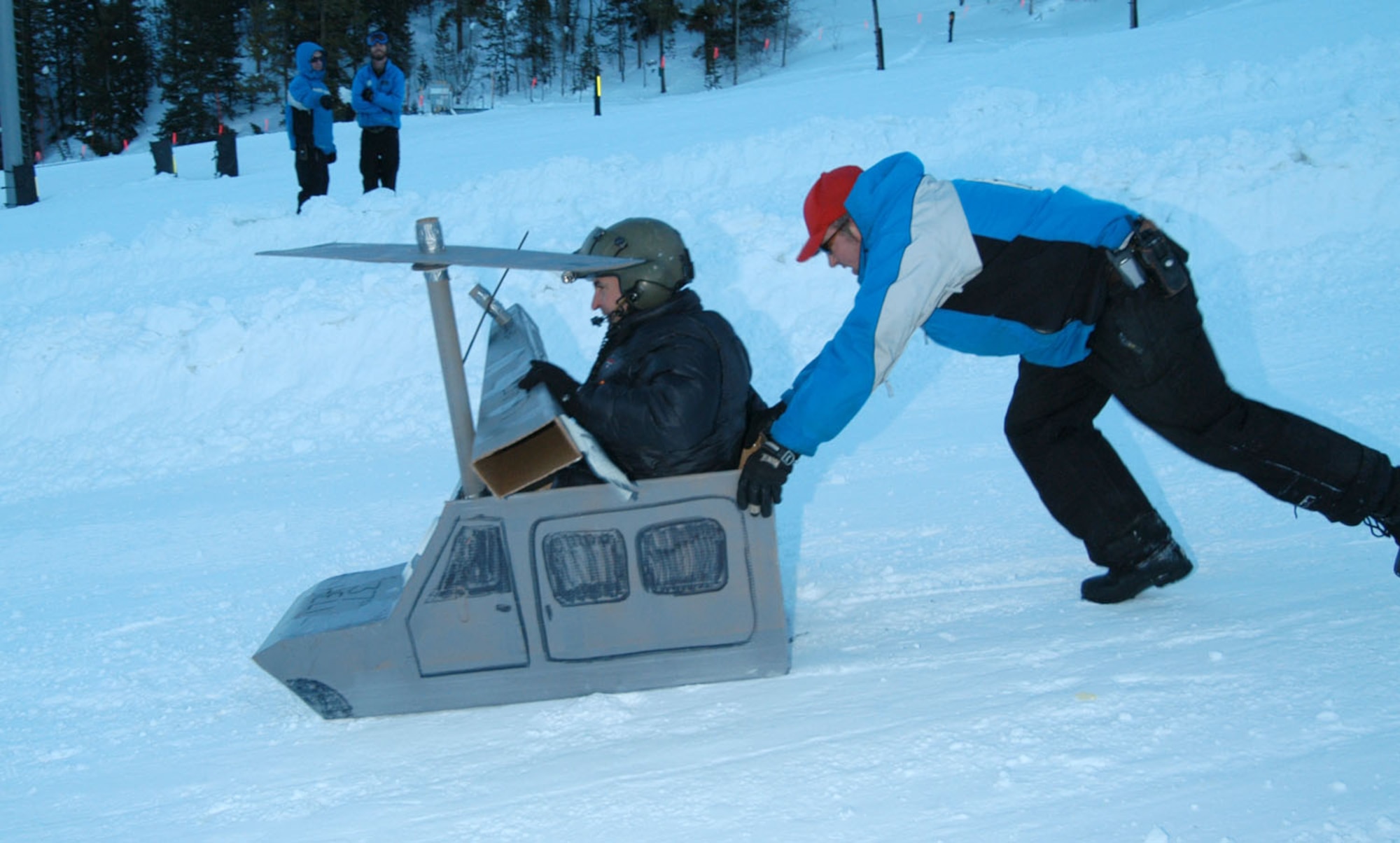 A SnoFest cardboard derby team builds up momentum as they slide down the mountain Jan. 26. SnoFest, held in Keystone, Colo., is an annual ski weekend targeted at military members and their families. Approximately 3,400 servicemembers and their families attended the SnoFest 2008 event. (U.S. Air Force photo/Todd Ryan)
