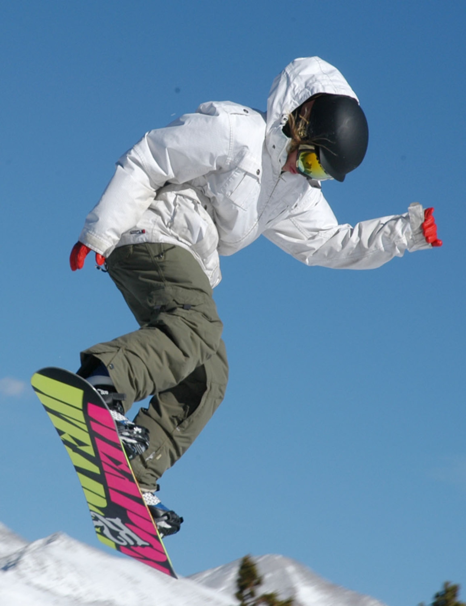 A SnoFest snowboarder braces for landing after floating through the Rocky Mountain air Jan. 26. SnoFest, held in Keystone, Colo., is an annual ski weekend targeted at military members and their families. Approximately 3,400 servicemembers and their families attended the SnoFest 2008 event. (U.S. Air Force photo/Todd Ryan)