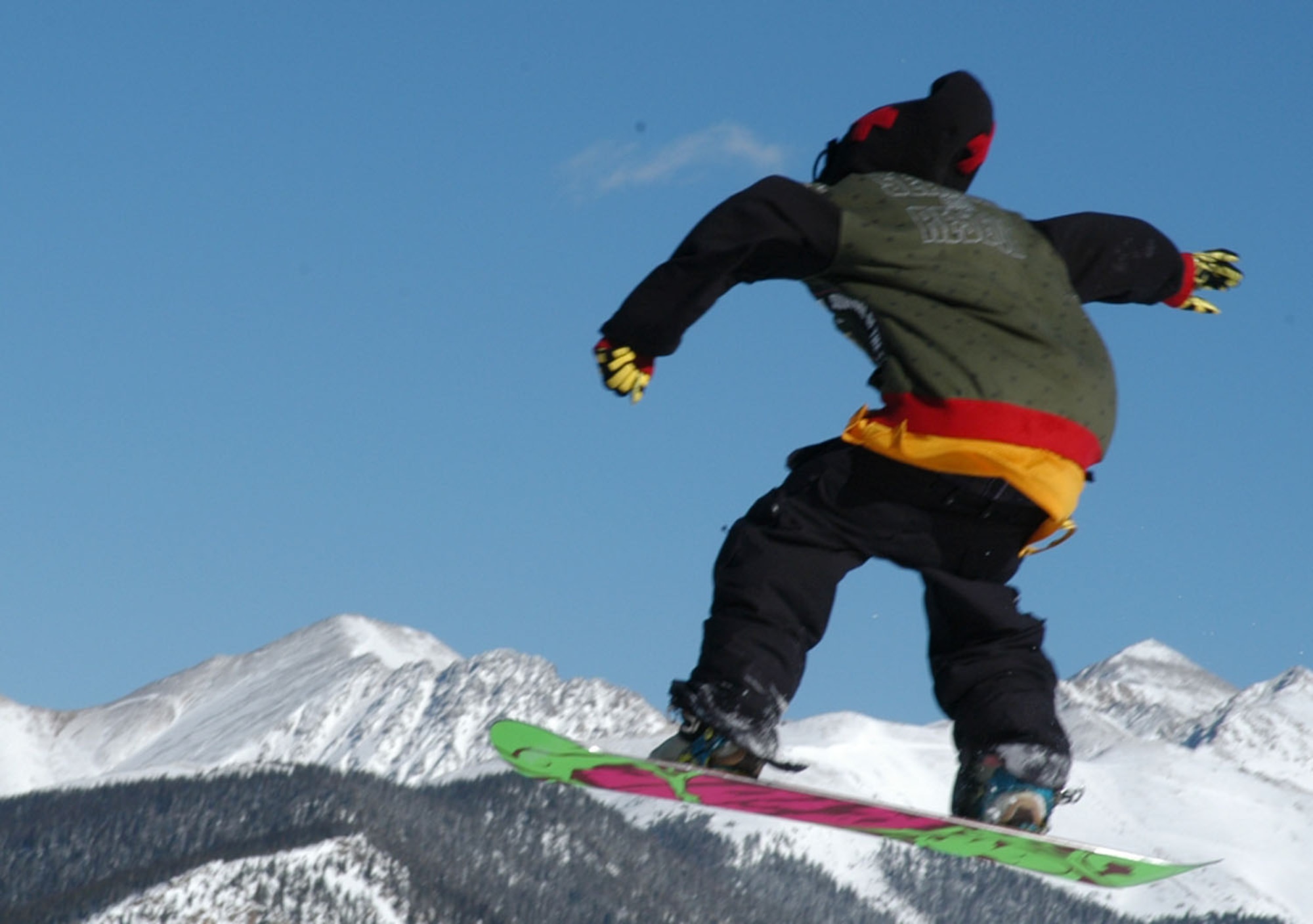A SnoFest snowboarder catches air over the Rocky Mountains Jan. 26. SnoFest, held in Keystone, Colo., is an annual ski weekend targeted at military members and their families. Approximately 3,400 servicemembers and their families attended the SnoFest 2008 event. (U.S. Air Force photo/Todd Ryan)