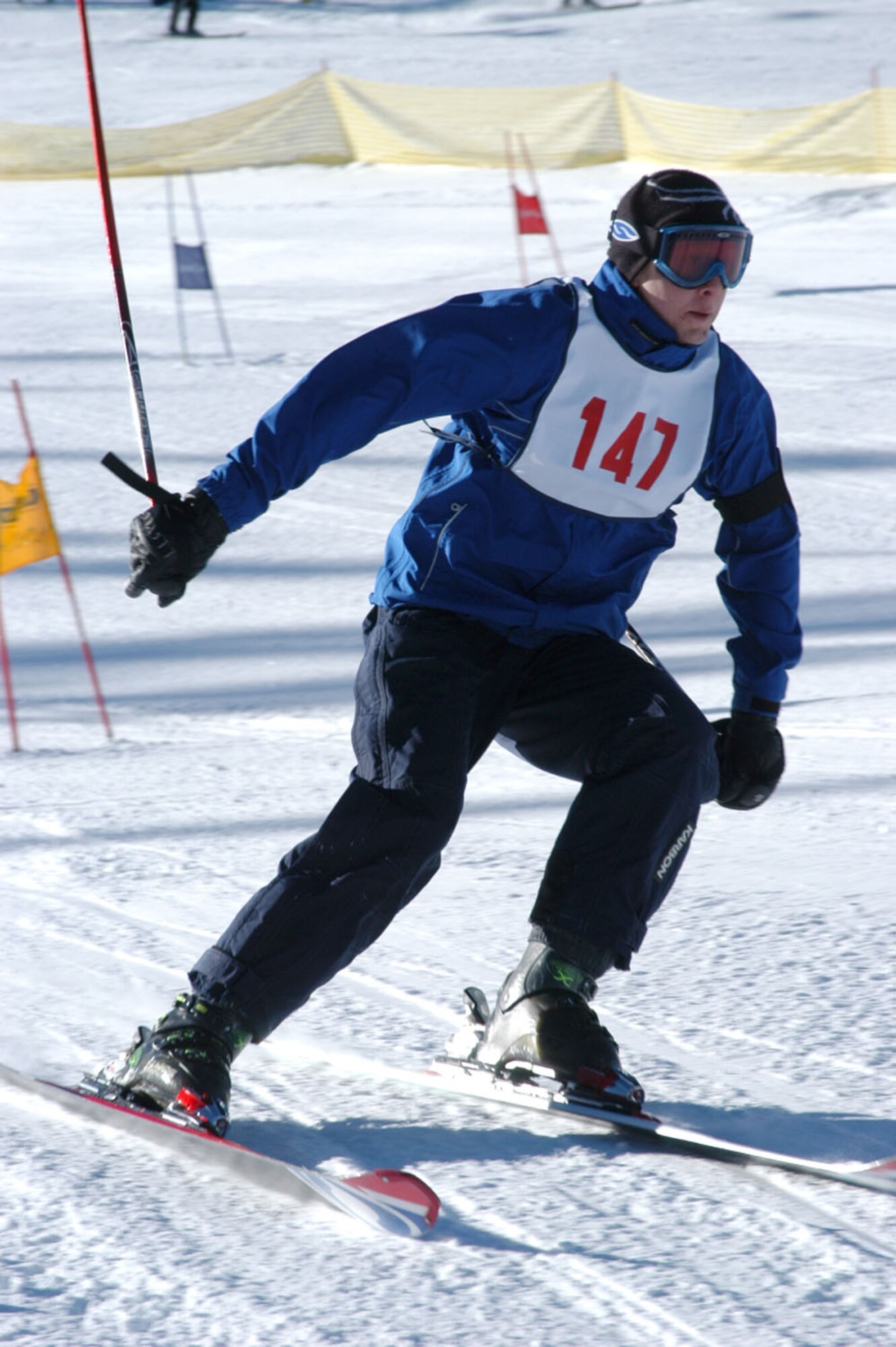A SnoFest skier guides his way through the National Standard Race, or ‘NASTAR’ course Jan. 26. SnoFest, held in Keystone, Colo., is an annual ski weekend targeted at military members and their families. Approximately 3,400 servicemembers and their families attended the SnoFest 2008 event. (U.S. Air Force photo/Todd Ryan)