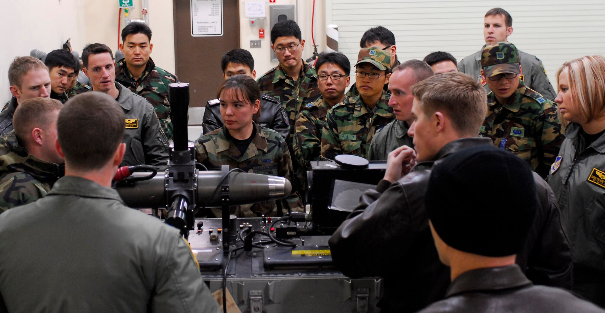 KUNSAN AIR BASE, South Korea -- U.S. Air Force and Republic of Korea Air Force pilots observe a missile testing procedure during Iron Viper here Jan. 30.  The Iron Viper program is a quarterly event that allows pilots to experience actual munitions build-up within the Munitions Storage Area using the same facilities and munitions that would be used during contingency operations. Pilots are able to experience "hands on" training as AMMO experts take them through the start-to-finish breakout, assembly and delivery of various bombs, missiles, chaff, flare, and 20mm bullets. (U.S. Air Force photo/Senior Airman Giang Nguyen)