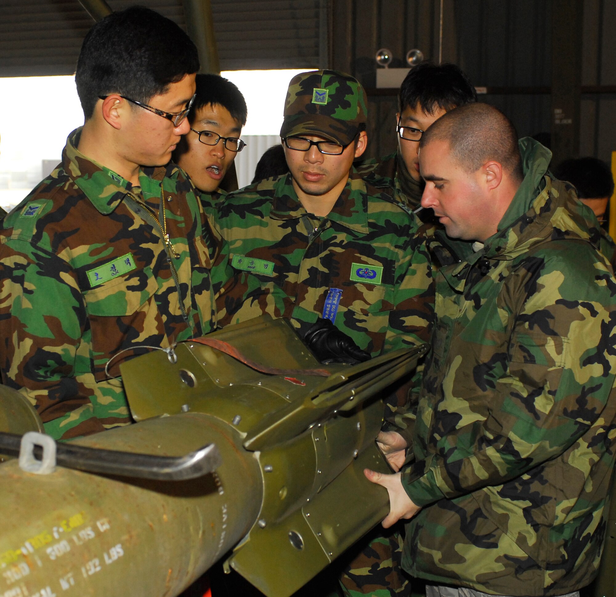 KUNSAN AIR BASE, South Korea -- U.S. and Republic of Korea Airmen assemble a Guided Bomb Unit during Iron Viper here Jan. 30.  The Iron Viper program is a quarterly event that allows pilots to experience actual munitions build-up within the Munitions Storage Area using the same facilities and munitions that would be used during contingency operations. Pilots are able to experience "hands on" training as AMMO experts take them through the start-to-finish breakout, assembly and delivery of various bombs, missiles, chaff, flare, and 20mm bullets. (U.S. Air Force photo/Senior Airman Giang Nguyen)