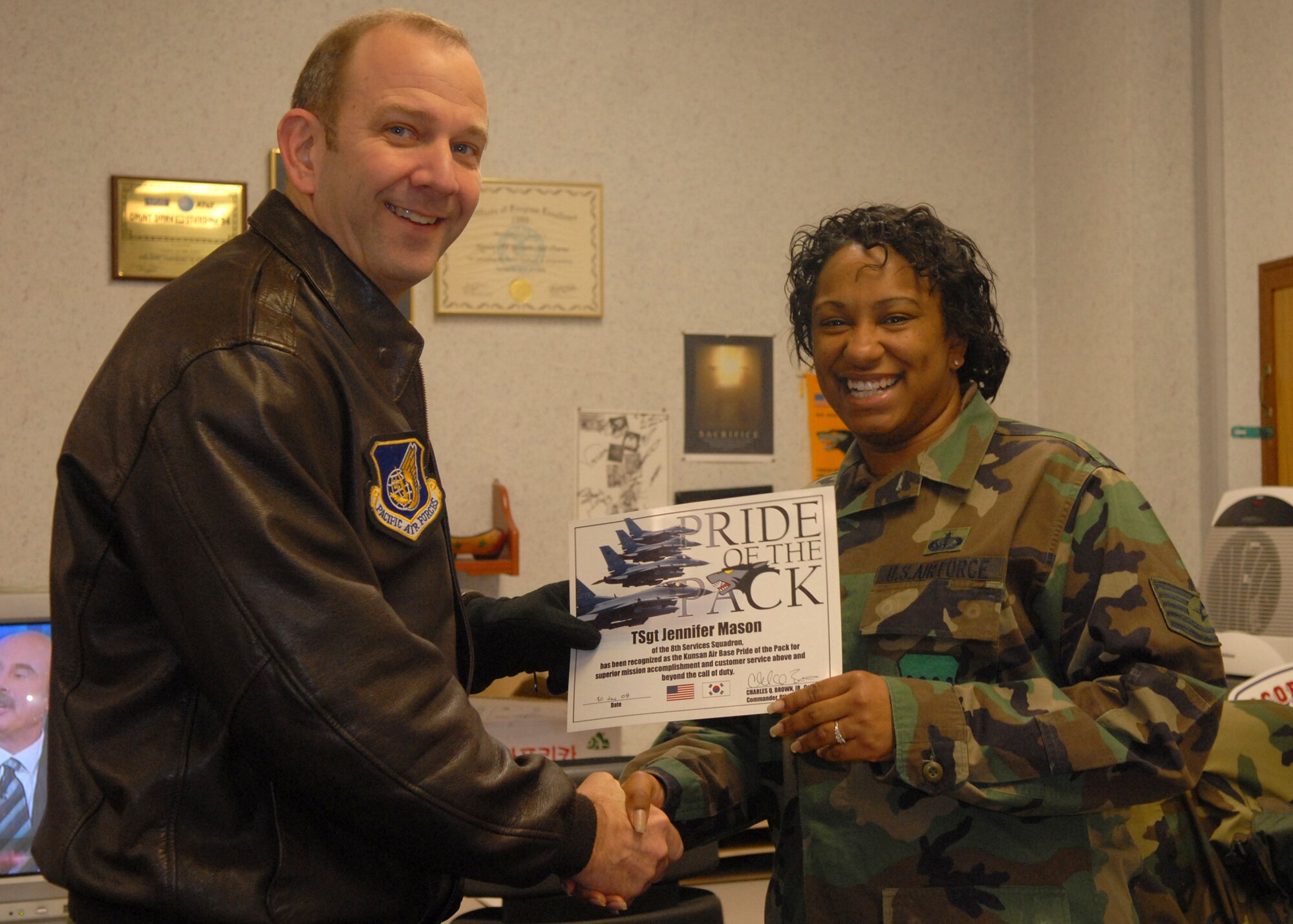KUNSAN AIR BASE, South Korea -- Colonel Creig Rice, 8th Fighter Wing vice  commander, congratulates Tech. Sgt. Jennifer Mason, 8th Services Squadron NCO in charge of the Community Activity Center and Base Coordinator here Jan. 30. Sergeant Mason was selected as the 8th Fighter Wing's Pride of the Pack for the week of Jan. 28.  (U.S. Air Force photo/Staff Sgt. Araceli Alarcon) 