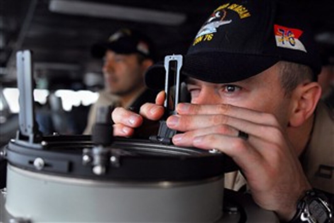 U.S. Navy Lt. Thomas Louden takes readings from a bearing ring aboard the Nimitz-class aircraft carrier USS Ronald Reagan in the Pacific Ocean, Jan. 28, 2008. 