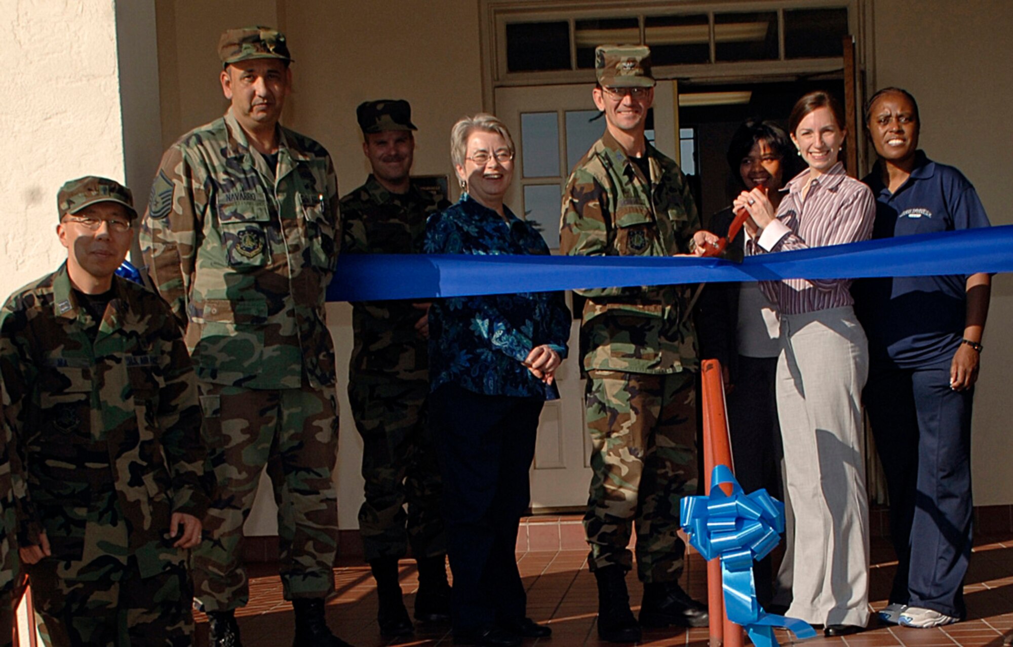 Col. Joseph Schwarz, 61st Air Base Wing commander, cuts the ribbon to mark the opening of the Airmen and Family Readiness Center on Fort MacArthur, Jan. 16.  The satellite office has a resource center, computers for customer use and a classroom.    Services are available for active duty members, spouses, retirees, reservists and DoD civilians. The satellite office a full spectrum of services includes:  Air Force Aid, job search/resumes, family life education, family readiness, personal financial management, relocation, k-12 school information, transition and volunteer opportunities.  The office is located on the second floor of Bldg. 37. It will be open Tuesdays and Thursdays 9 a.m. to noon and Wednesdays noon to 3 p.m. starting Feb. 5. (Photo by Paul Testerman)