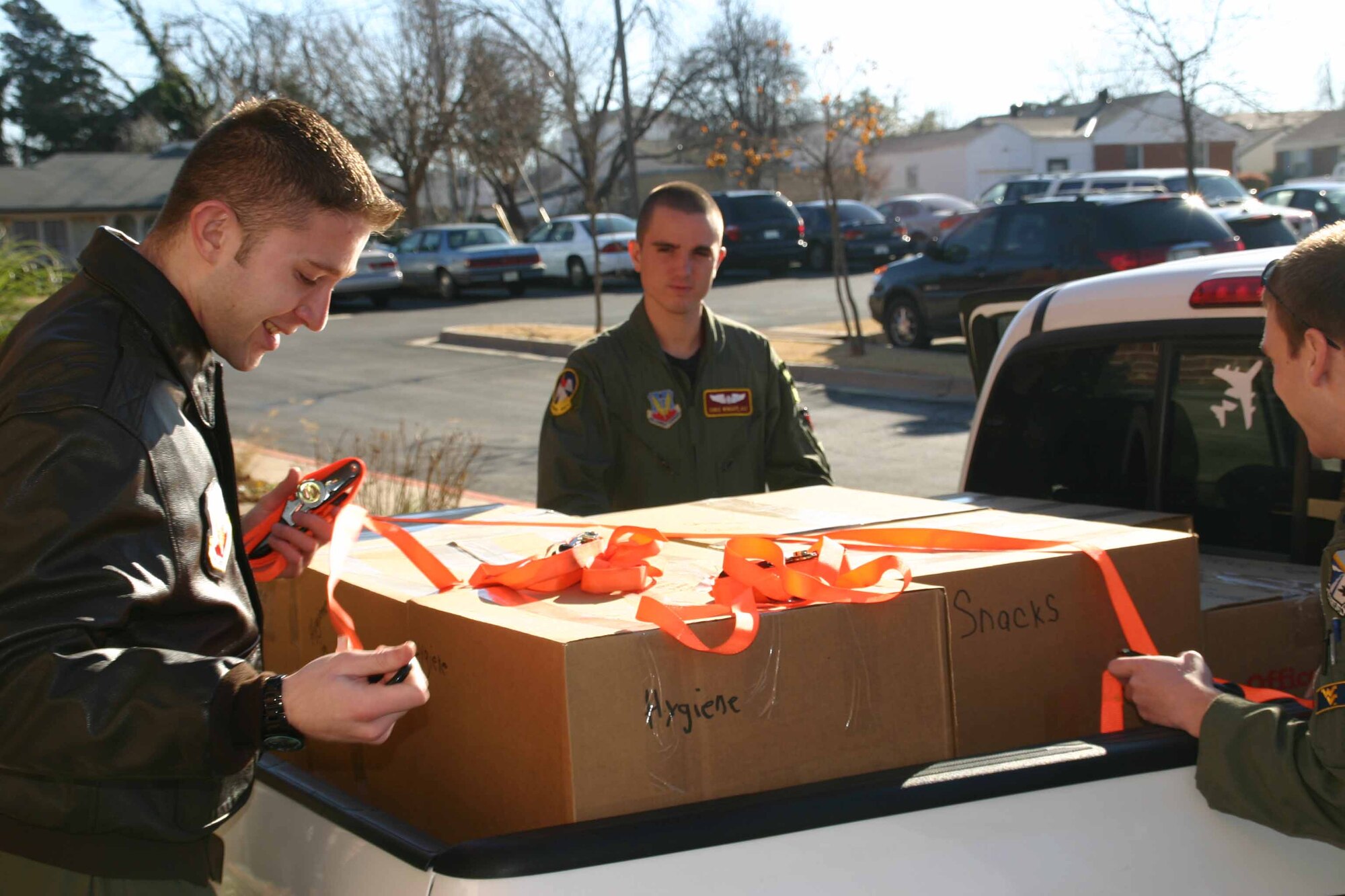 Members of the 964th Airborne Air Control Squadron help load two truck beds full of boxes of goodies for deployed Airmen and needy children in Ecuador. The donations came from Philip Neri Parish in Midwest City as part of their Treats for Troops program. Photo by SrA Lorraine Amaro.  (Air Force photo)

 
