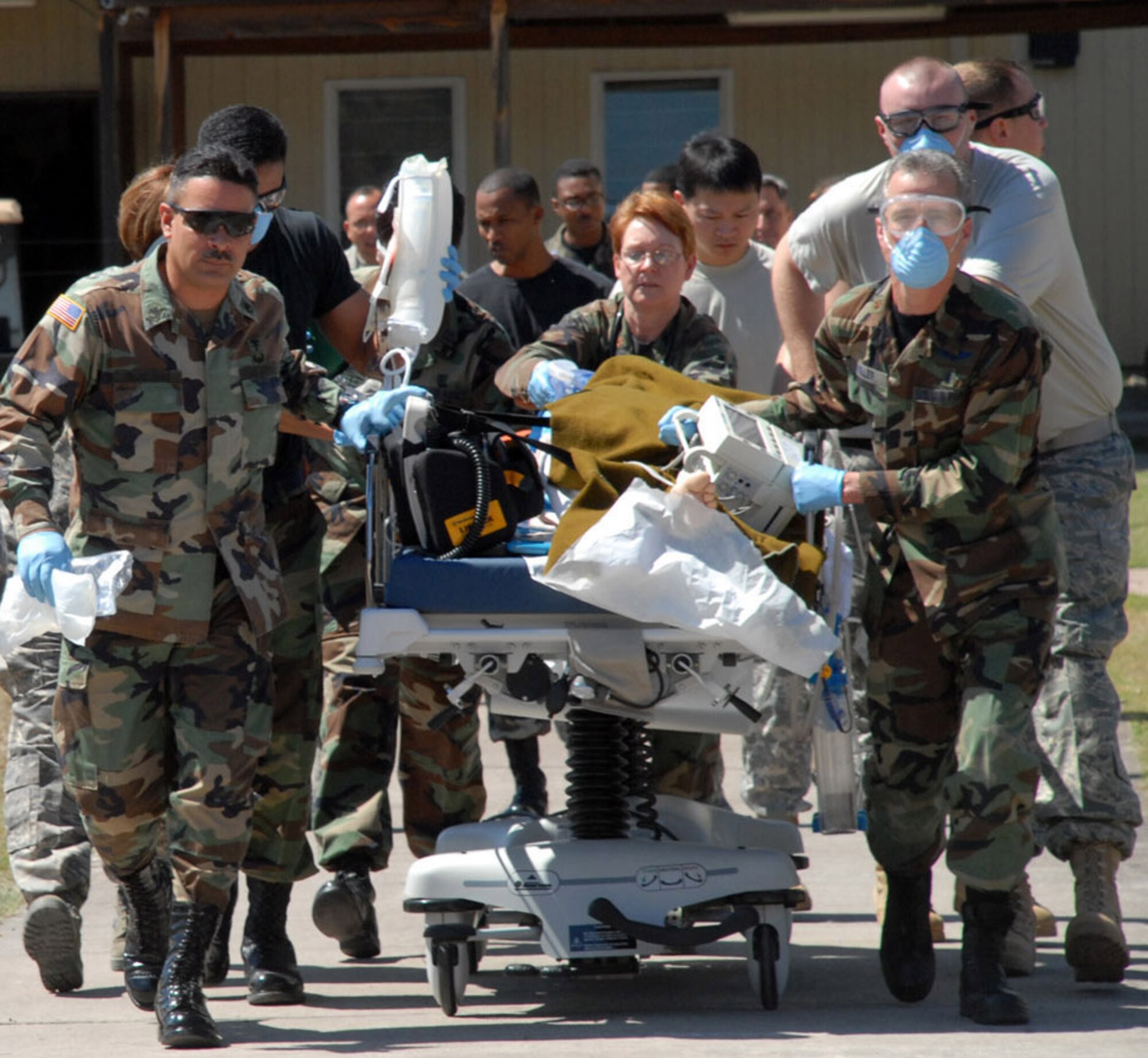 SOTO CANO AIR BASE--Joint Task Force-Bravo members wheel a local Honduran gunshot victim to an awaiting UH-60 MEDEVAC helicopter at Soto Cano Air Base, Honduras Jan. 31. Because of the close relationship with the local community, a Honduran doctor at the local hospital in Comayagua requested assistance with transporting the patient to Tegucigalpa. (U.S. Air Force photo by Tech. Sgt. William Farrow)