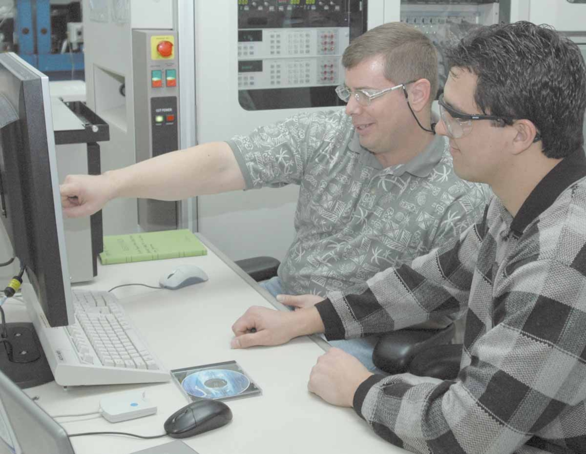 Jim Danscuk, electronics engineer and Nick Hahn, project leader with the 555th Software Maintenance Squadron, prepare to load the final version of the test program set software.  (Air Force photo by Ron Mullan)