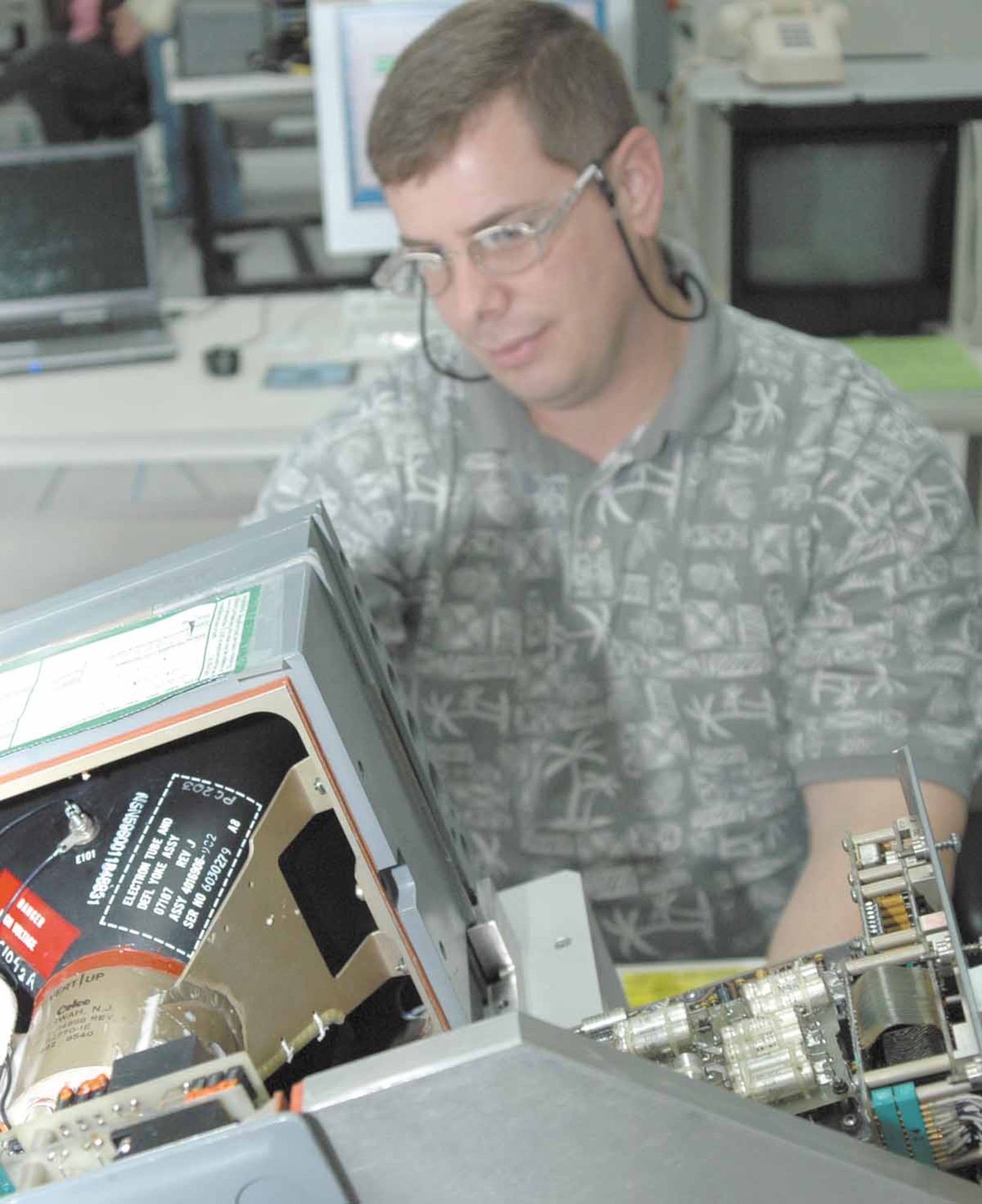 Jim Danscuk, an electronics engineer with the 555th Software Maintenance Squadron runs a diagnostic test on a B-1 Bomber vertical situation display unit