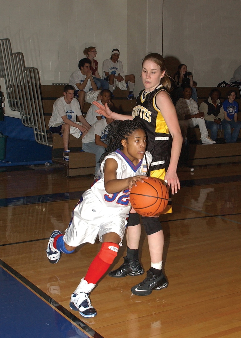 Lackland Eagle's point guard Shana Holmes races by a defender, trying to score. She had 37 points in a 70-67 victory over Brackett High School on Jan. 29. (USAF photo by Alan Boedeker)                            