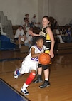 Lackland Eagle's point guard Shana Holmes races by a defender, trying to score. She had 37 points in a 70-67 victory over Brackett High School on Jan. 29. (USAF photo by Alan Boedeker)                            