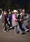 A group of children from Lackland Elementary School perform the "Cotton-Eyed Joe" during the school's Cowboy Breakfast on Jan. 25. (USAF photo by Robbin Cresswell)