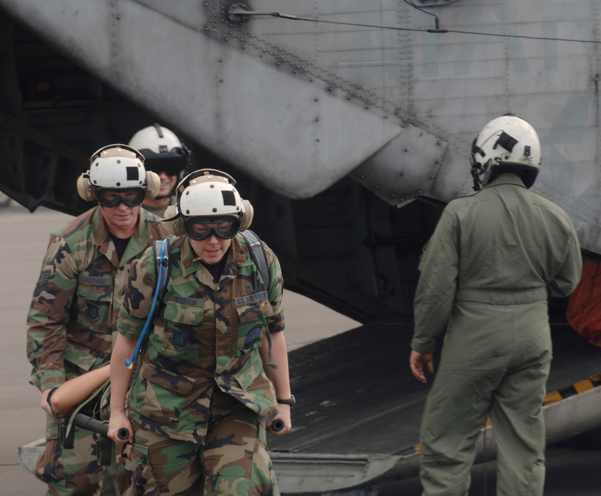 KONA, Hawaii - Maj. Laura Peterson, and Tech. Sgt. Marcus Andrade of the 3rd Expeditionary Medical Squadron, Elmendorf Air Force Base, Alaska, hone their helicopter evacuation skills during a Pacific Lifeline training exercise at the Kona International Airport, Kona, Hawaii, Jan 30. The 363rd Heavy Mobile Helicopter Squadron, Kaneohe Marine Corps Base, Hawaii, provided a CH-53D Sea Stallion and aircrew members to provide realistic hands-on training. More than 80 members of the 3rd EMEDS are participating in Pacific Air Forces first-ever total force humanitarian assistance and disaster relief exercise taking place from three locations within the Hawaiian Islands, Jan. 20 to Feb. 9. (U.S. Air Force photo by Staff Sgt. Patrick Mitchell.)
