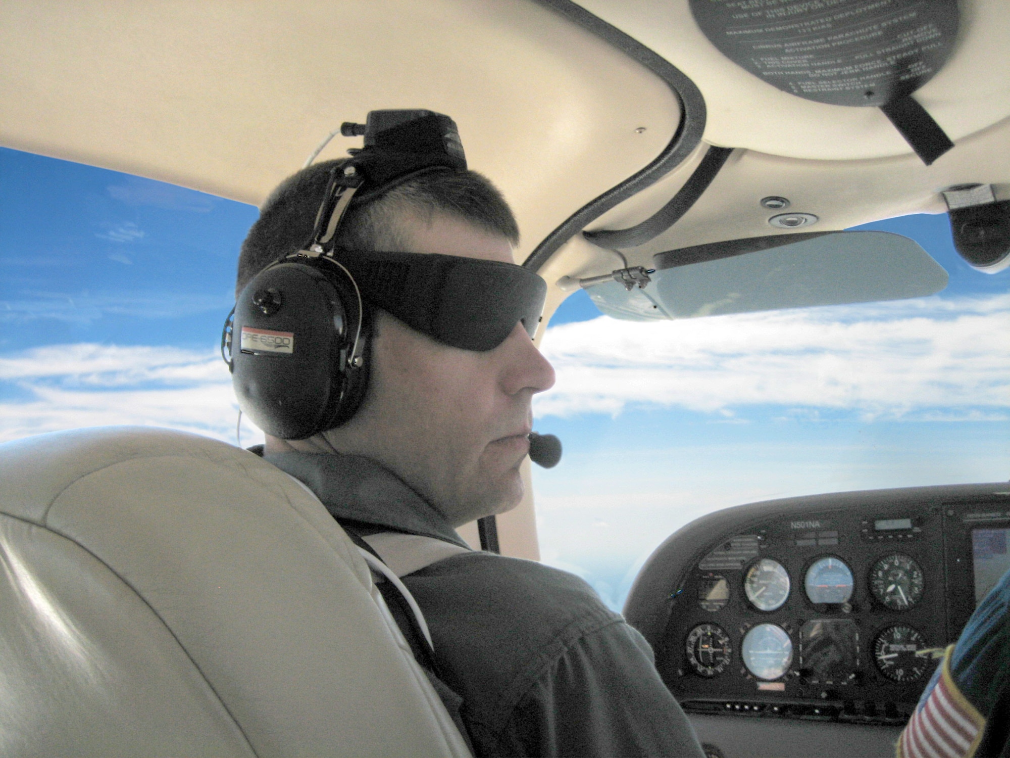 Test subject Jay Brandon, a senior research engineer in the Flight Dynamics Branch at NASA Langley Research Center, wears opaque black goggles to literally “fly blind” during 3D audio tests conducted by the Air Force Research Laboratory Human Effectiveness Directorate at the NASA Langley Research Center in Virginia. The instrumentation on top of Brandon's head is a head-tracking system that measures the orientation of the pilot's head for updating the 3D audio display. (Photo courtesy AFRL)