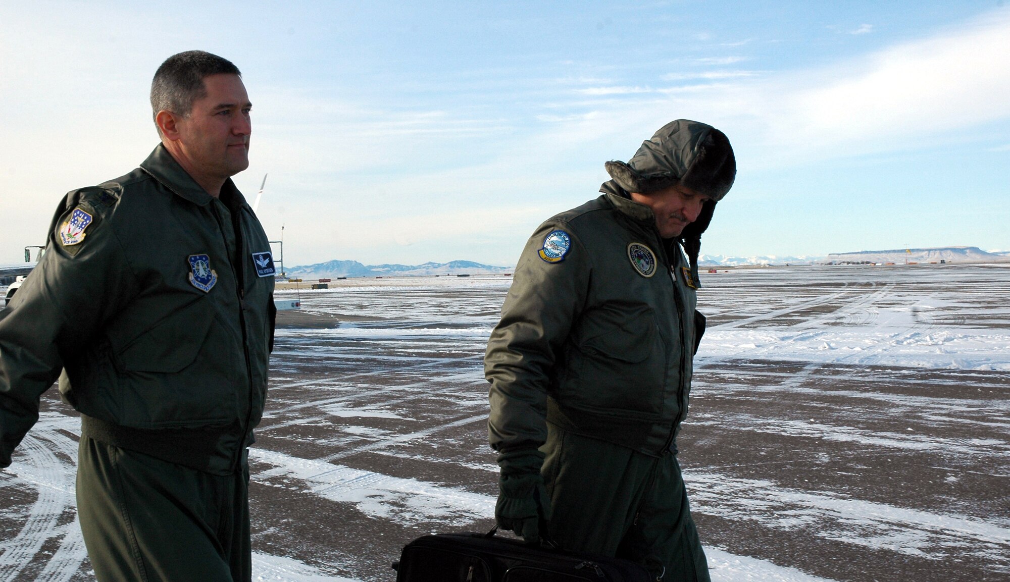 Col. Paul Gydesen (left), 341st Space Wing vice commander, and Navy Capt. Gary Foster, Strategic Command, carry their supplies to the Airborne Command Post. Colonel Gydesen went on his first flight with the ABNCP Jan. 16. (U.S. Air Force photo/Airman 1st Class Emerald Ralston)