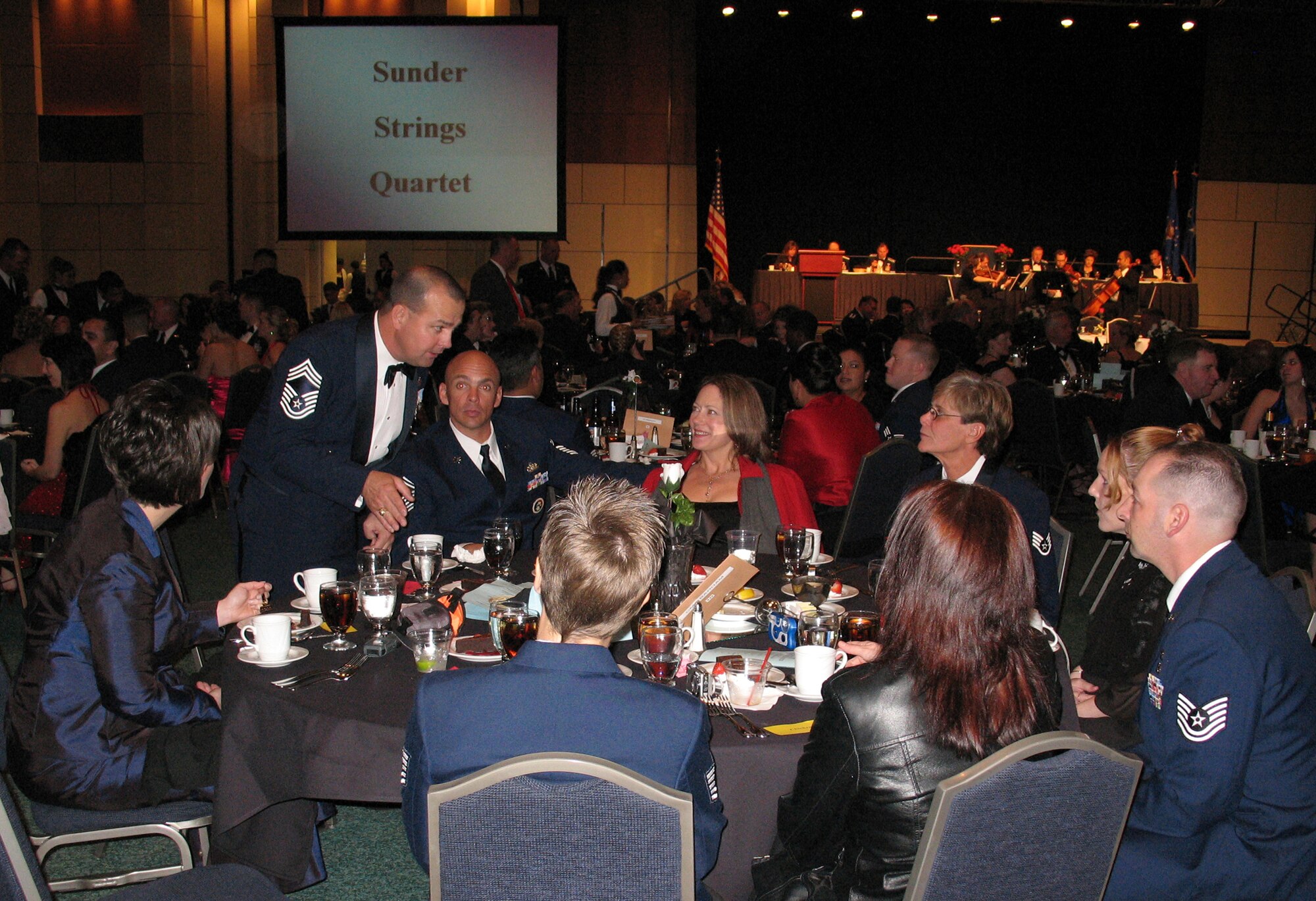 With a table full of 301st civil engineers, Chief Ronnie Barham, 301st CES, (standing) has a captive audience to present his Unit Training Assembly ideas at the recent 301st Fighter Wing Awards Banquet. (U.S. Air Force Photo/Frank Garcia)