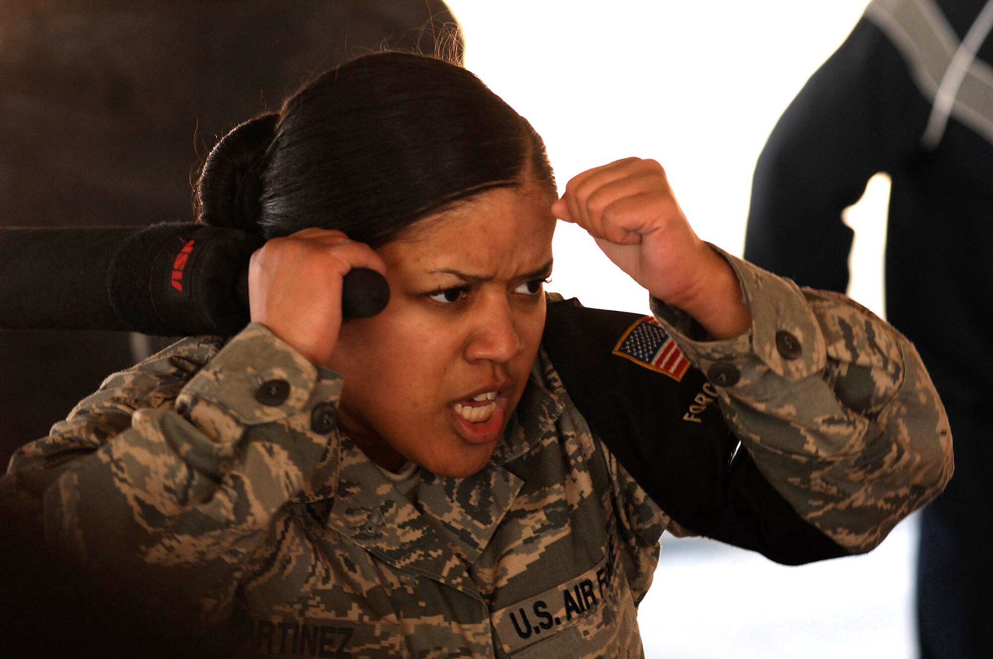 Airman 1st Class Carla Martinez gets her game face on as she prepares to defend herself Jan. 24 during self-defense tactics training with batons at an air base in the Southwest Asia . The self-defense training familiarizes Airmen with how to use non-lethal force to defend themselves. Airman Martinez is assigned to the 386th Expeditionary Security Forces Squadron and is deployed in support of Operation Iraqi Freedom. (U.S. Air Force photo/Senior Airman Patrick Dixon) 