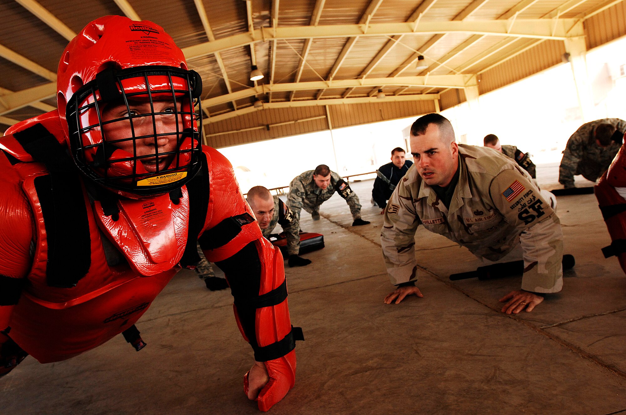 Airmen do pushups for a mistake made Jan. 24 during self-defense tactics training at an air base in Southwest Aisa. The self-defense training familiarizes Airmen with how to use non-lethal force to defend themselves. The Airmen are assigned to the 386th Expeditionary Security Forces Squadron and are deployed in support of Operation Iraqi Freedom. (U.S. Air Force photo/Senior Airman Patrick Dixon) 