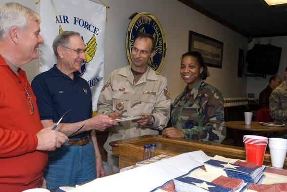 The Fort Worth Chapter of Air Force Association sponsored a pancake breakfast during the holidays for 136th Airlift Wing, Texas Air National Guard, deploying members in support of  Operation Enduring Freedom. More than two dozen families were served in the early morning hours. Pictured are Chapter members Bill Lawson (left) and Dan Heth with 136st Maintenance Squadron Tech. Sgt. Charles Migot and 301st Fighter Wing First Sergeant, Master Sgt. Udrika Baldwin. (U.S. Air Force Photo)