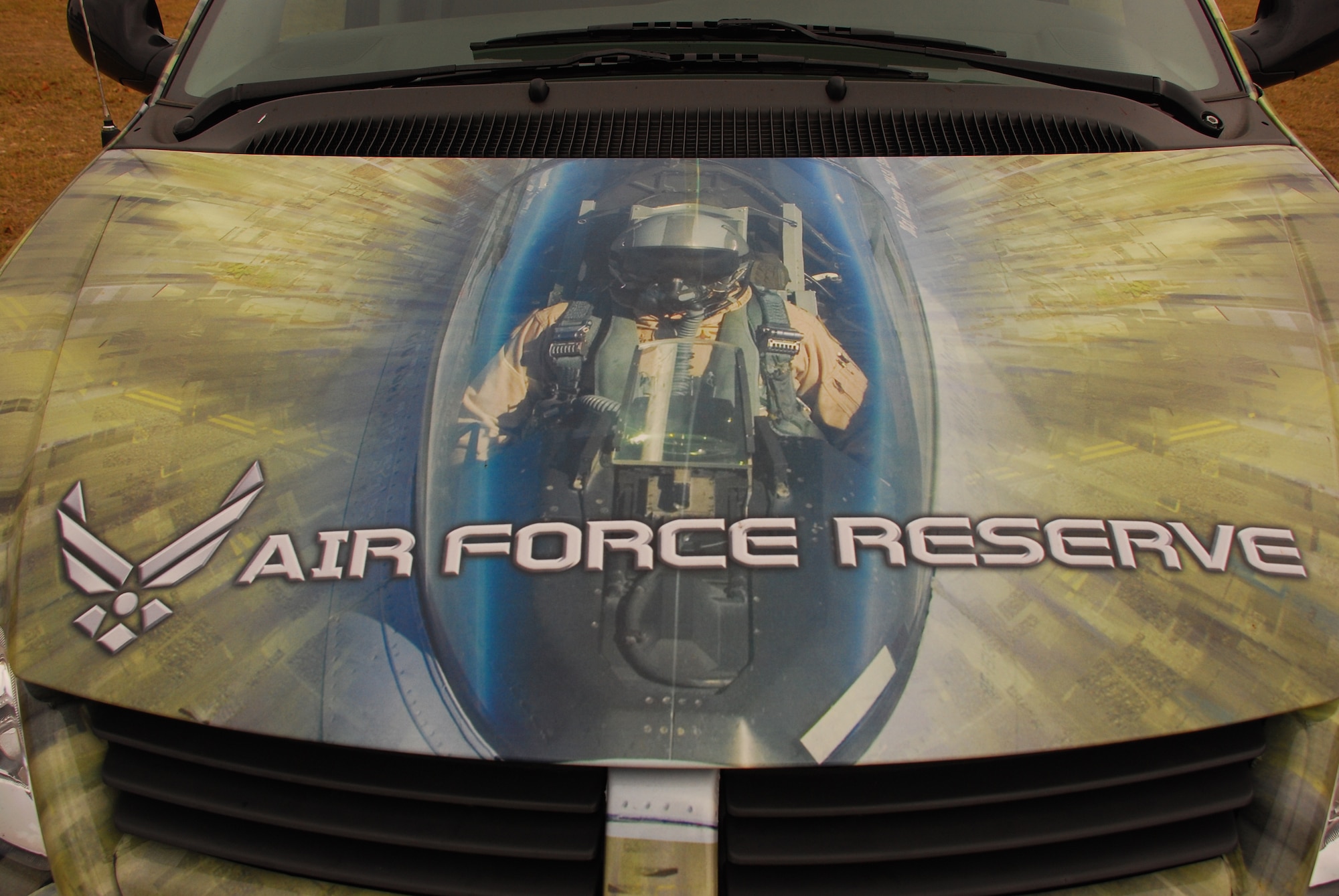 The 457th Fighter Squadron's F-16 covers more than just Texas skies, they adorn the 301st Fighter Wing recruiter' mini van. Heat is applied to a vinyl wrap completely covering a vehicle in an Air Force Reserve Command advertisement. (U.S. Air Force Photo/Tech. Sgt. Julie Briden-Garcia)