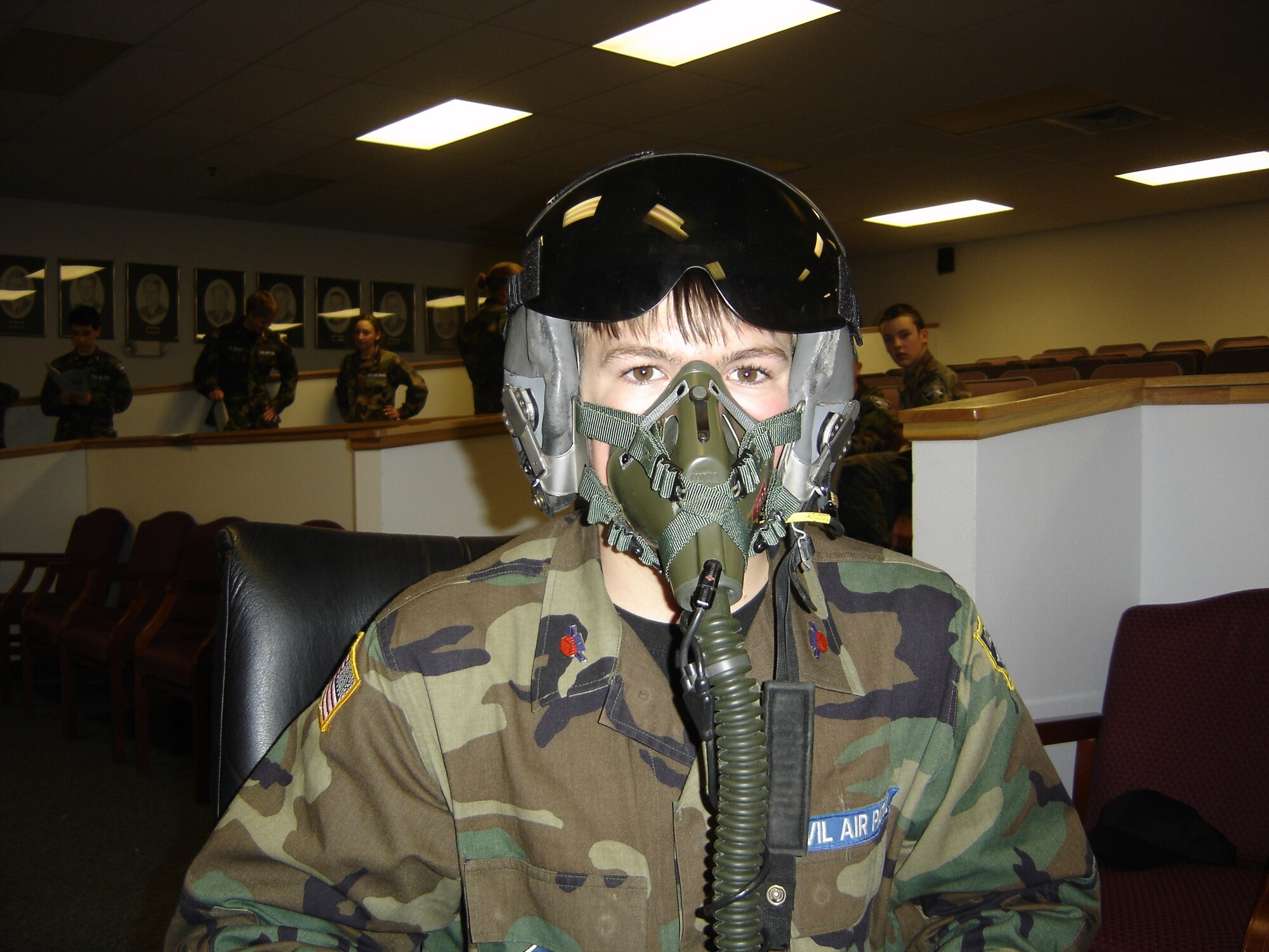 Cadet Cole Guidoni tries on a pilot's helmet during a class on aerospace power at the Civil Air Patrol encampment. The encampment was held at Malmstrom from Jan. 11 to 27. (Courtesy photo)