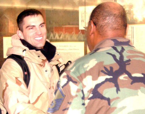 BALTIMORE-WASHINGTON INTERNATIONAL AIRPORT, Md. -- Tech. Sgt. Joey Keyes, 459th Aircraft Maintenance Squadron information management craftsman, shakes hands with Master Sgt. Tony Bright, 459th Maintenance Operations Flight, upon the former's return from deployment Jan. 16. (U.S. Air Force photo/Capt. Tim Smith)