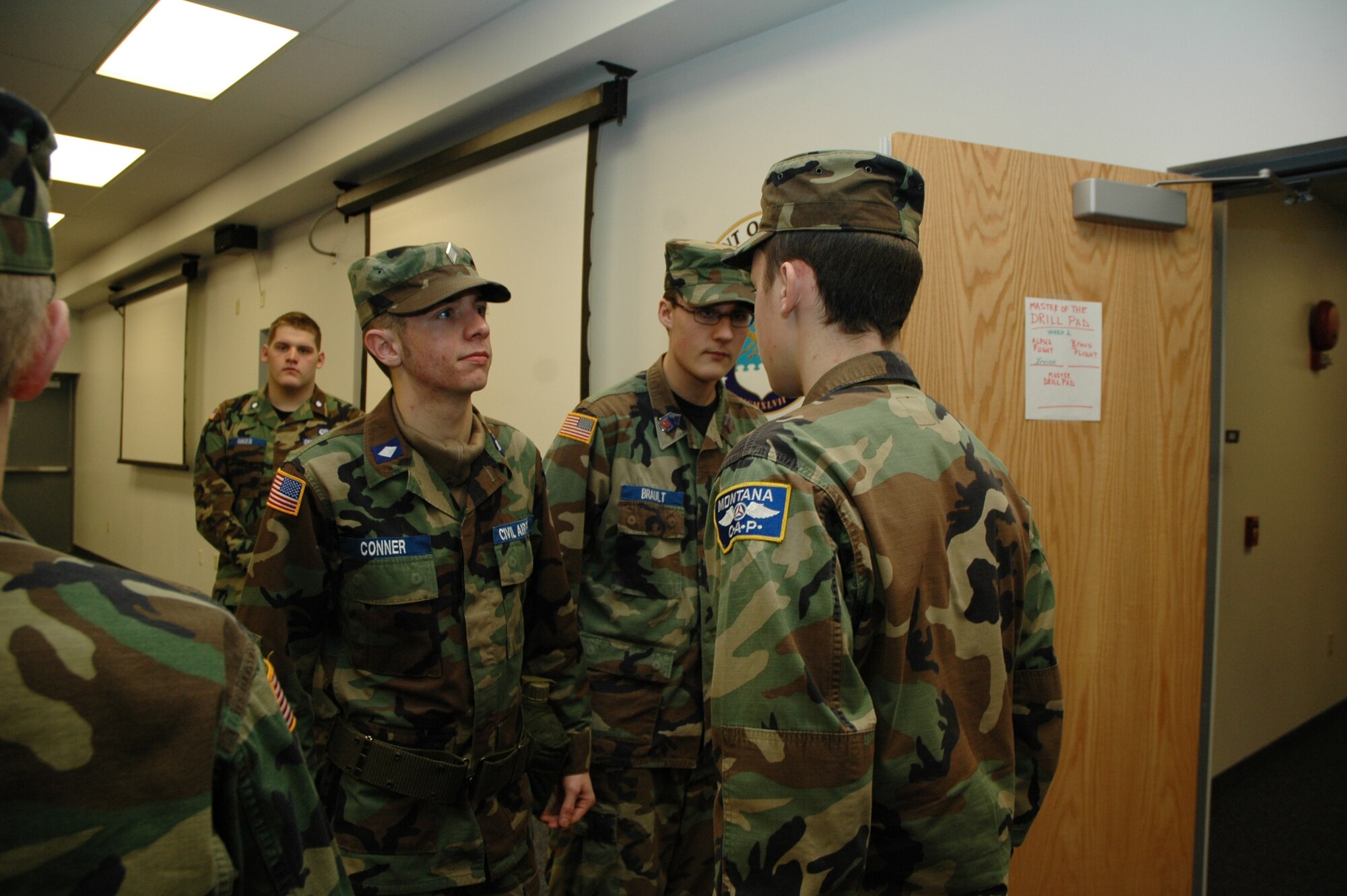 Cadet Maj. Aaron Conner and Cadet Chief Chris Brault perform uniform inspections during a Civil Air Patrol encampment held at Malmstrom from Jan. 11 to 27. (U.S. Air Force photo/Airman 1st Class Emerald Ralston)