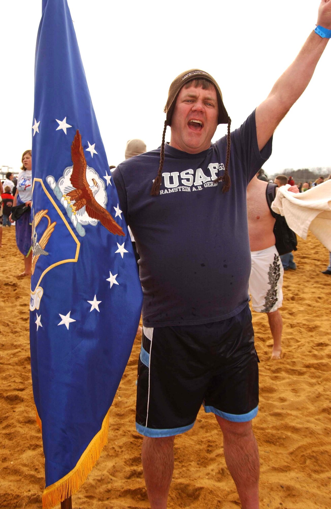 ANNAPOLIS, Md. -- Tech. Sgt. Warren Hiller, 459th Aircraft Maintenance Squadron, victoriously holds the Air Force Reserve Command flag during the Maryland State Police Polar Bear Plunge Jan. 26. Team Andrews members of the 459th Air Refueling Wing and the 79th Medical Wing were among nearly 9,000 people who hopped in the Chesapeake Bay at Sandy Point Park to raise money for Special Olympics Maryland. Sergeant Hiller's team, Crazy Yankee, raised more than $1,300 in donations. (U.S. Air Force photo/Staff Sgt. Amaani Lyle)