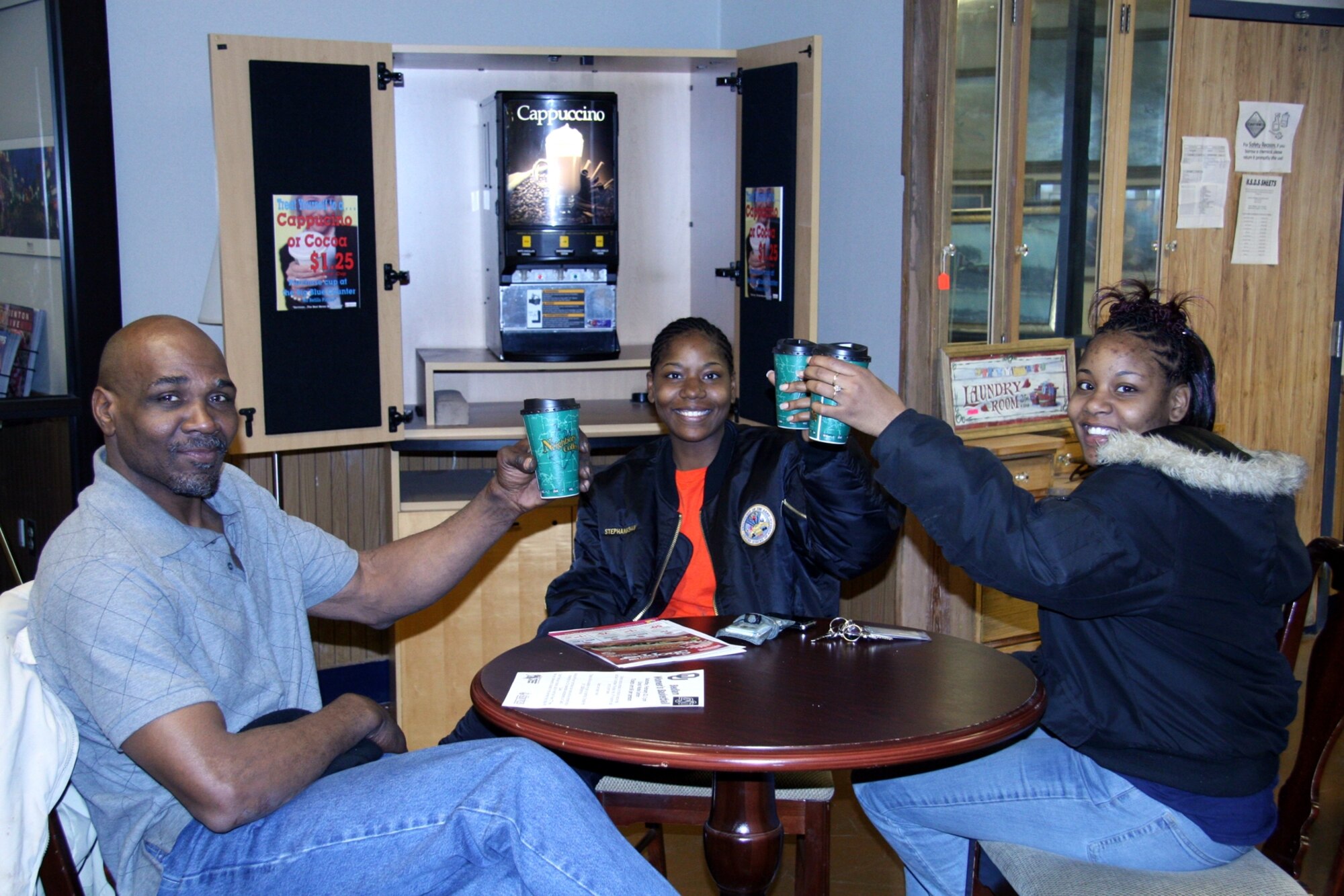 Madarry Smiley, Kimberly Shaw and Stephanie Shaw enjoy a hot cappuccino at the Services Mall, Bldg. 478, on a cold January morning.  The new cappuccino service allows patrons to relax and enjoy their mall visit.  A 16-ounce cup can be purchased at the big blue counter for $1.25.