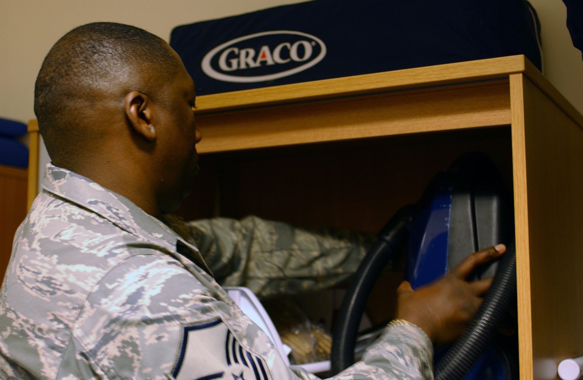 Master Sgt. Mark Gilliard, 48th Mission Support Squadron Airman and Family Readiness Center superintendent places a returned vacuum cleaner in a cabinet Jan. 31 at the Airmen’s Loan Locker at RAF Lakenheath, England. (U.S. Air Force photo by Airman 1st Class Kristopher Levasseur)