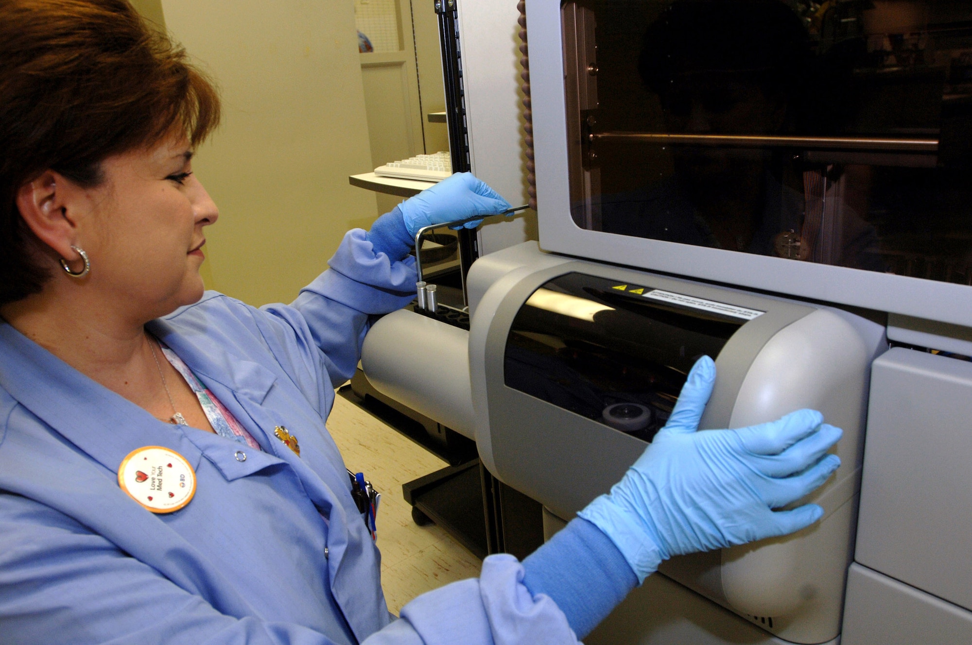 Carolina Collins loads reagents into the STA-R Evolution Jan. 16 at Wilford Hall Medical Center at Lackland Air Force Base, Texas. The equipment is a new addition to the lab and will increase productivity. The equipment will perform coagulation testing, the process in which blood clotting factors are analyzed, and compliance with therapeutic ranges for anti-coagulants is determined. Ms. Collins is a medical technologist in the 59th Laboratory Squadron. (U.S. Air Force photo/Senior Airman Erin M. Peterson) 
