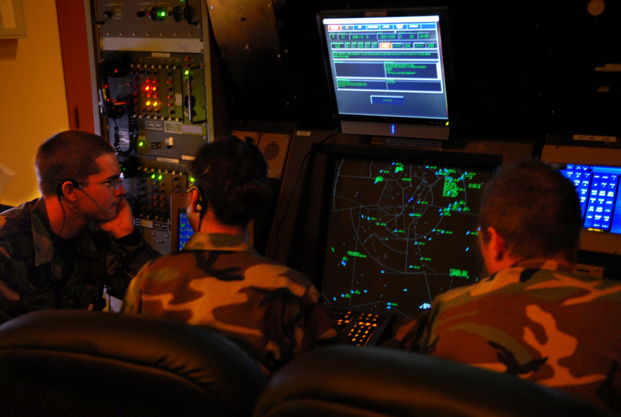 Senior Airman Erik Aarness, Staff Sgt. Janel Taylor, and Senior Airman Anthony Robertson, 56th Operations Support Squadron air traffic controllers, monitor the airspace to the south of Luke. There is another station behind them monitoring the airspace to the north; together they ensure the flow of air traffic remains smooth throughout Luke’s airspace. (photo by Airman 1st Class C.J. Hatch)