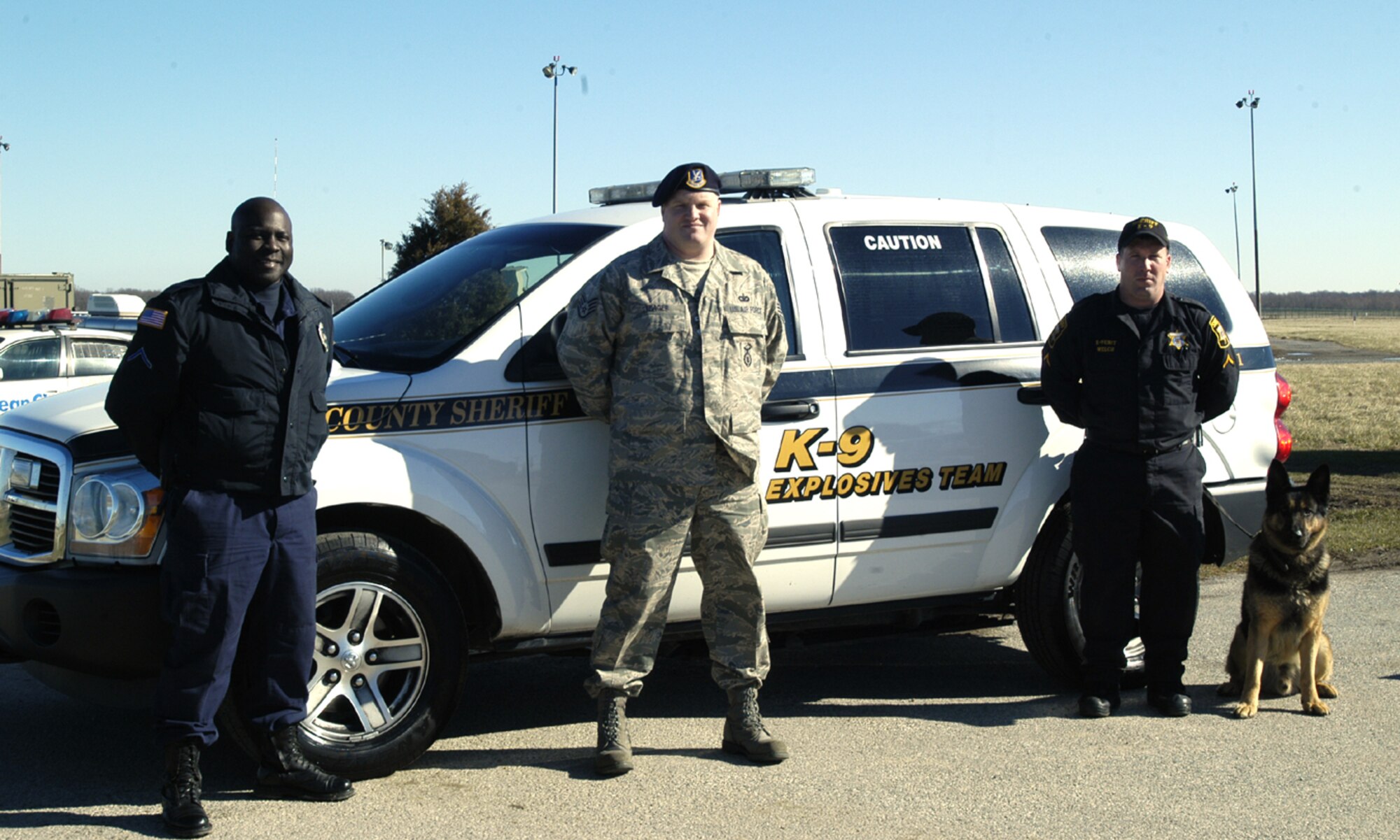 Cpl. Freddie Howard, Ocean City Police Department, Staff Sgt. Scott Yeager, 436th Security Forces Squadron military working dog handler, and Deputy 1st Class John Welch, Wicomico County Sheriff’s Office, work as a team and train hand in hand for their K-9 units. (U.S. Air Force photo/Airman 1st Class Shen-Chia Chu)