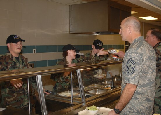 SEYMOUR JOHNSON AIR FORCE BASE, N.C. - Chief Master Sergeant Steve Sullens, Air Combat Command command chief master sergeant, talks with Senior Airman Robert O'Connor, 4th Services Squadron, while going down the lunch line at the Southern Eagle Dining Facility during his visit to the base Jan. 26. (U.S. Air Force photo by Senior Airman Chad Trujillo)