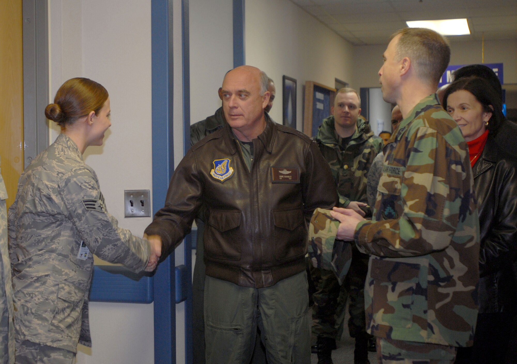 KUNSAN AIR BASE, South Korea -- Gen. Howie Chandler, Pacific Air Forces commander, shakes hands with Senior Airman Linn Aubrey, from the 8th Medical Support Squadron, while touring the clinic during his visit here Jan. 31. This is General Chandler's first visit to Kunsan since becoming the PACAF commander.  (U.S. Air Force photo/Staff Sgt. Darcie Ibidapo)