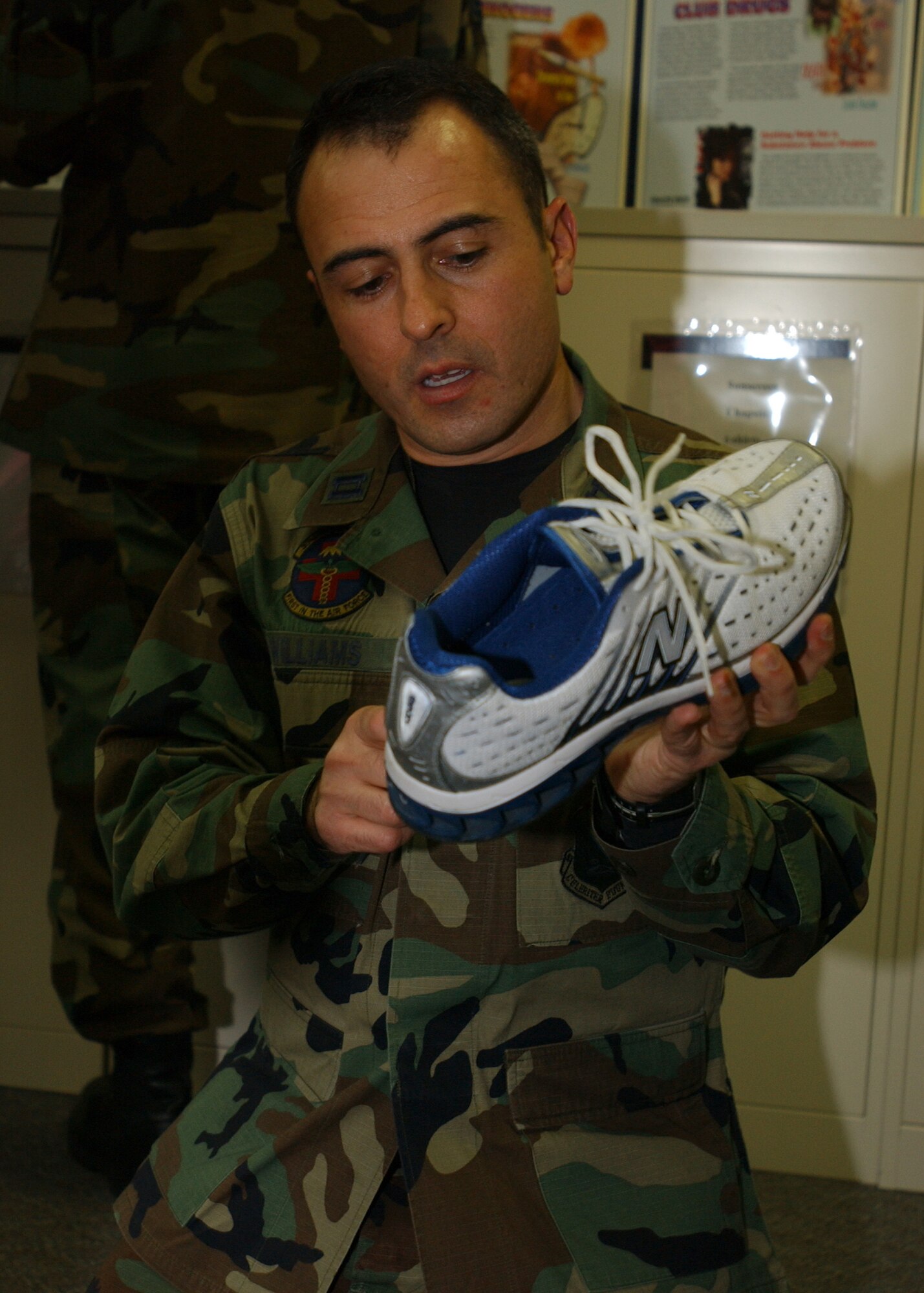 YOKOTA AIR BASE, Japan - Captain Joesph Williams, from the 374th Medical Operations Squadron, examines a running shoe during a running clinic at the Health and Wellness Center on Jan 23, 2008.  Captain Williams instructed participatants on proper running technique, common injuries, and provided a number of other helpful running tips. (U.S. Air Force photo by Airman First Class Jonathan Fowler)                         
