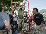WTMJ-4 Milwaukee chief meteorologist, John Malan, uses the Marines’ pull-up challenge at Summerfest as a backdrop for his afternoon forecast July 1. Marines challenged the music festival attendees to either perform a max set of pull-ups or a flexed-arm hang as long as possible to raise awareness of the Marine Corps. WTMJ 4 is the local affiliate for the National Broadcasting Company’s Milwaukee .