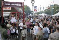 A 12-year-old boy attempts to pump out another pull-up in front of an impressed crowd July 1 at Summerfest. Marines challenged the music festival attendees to either perform a max set of pull-ups or a flexed-arm hang as long as possible to raise awareness of the Marine Corps.