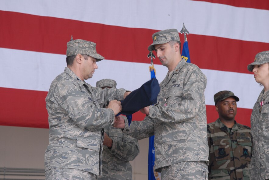Colonel Robert Nuanes, 8th Mission Support Group commander, and Maj. Thomas Angelo, 8th Mission Support Squadron commander, furl the MSS colors during the 8th Force Support Squadron activation ceremony here June 30. Both the 8th MSS and 8th Services Squadrons were inactivated as the 8th FSS was stood up.