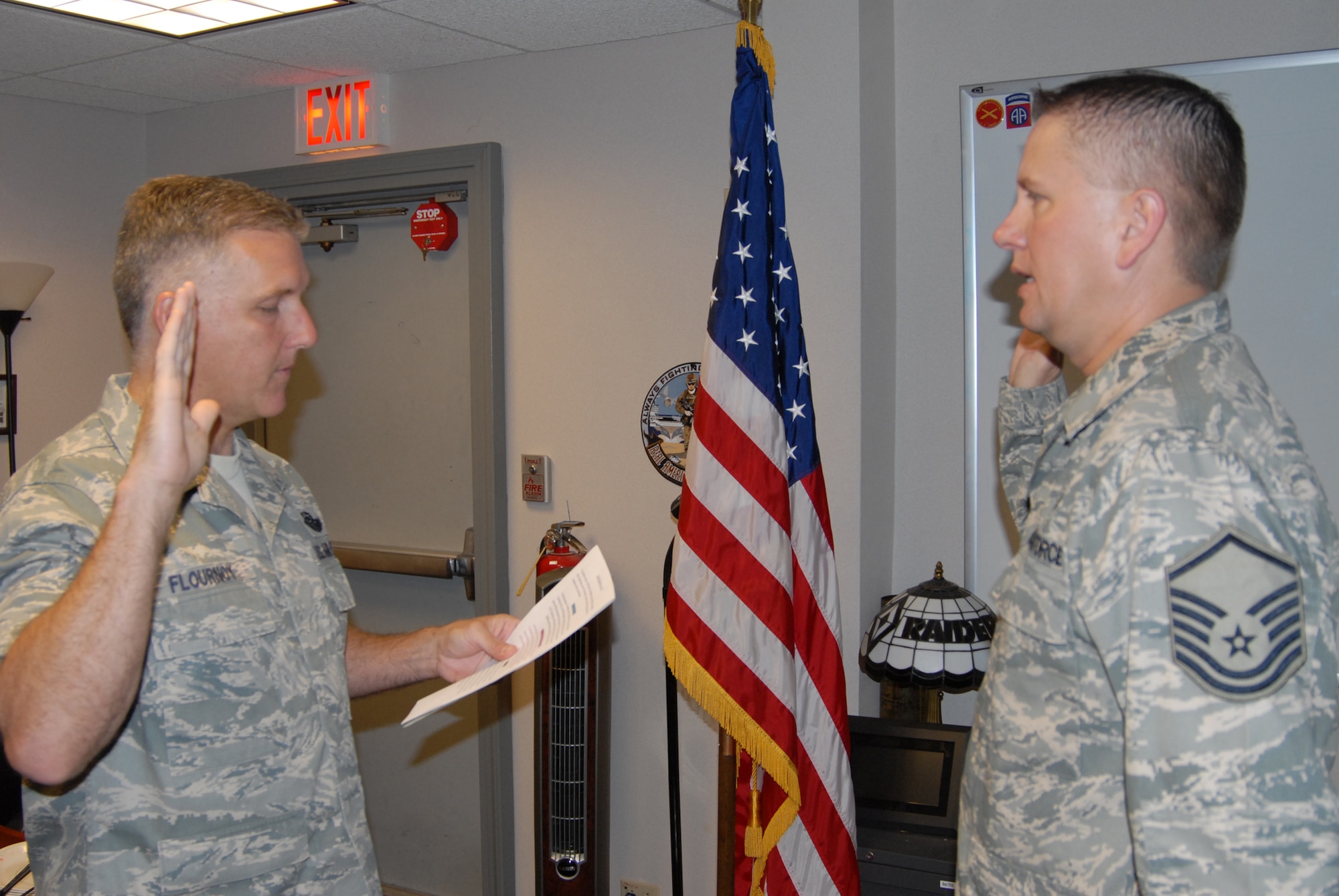 Col. John Flournoy, commander of the 932nd Airlift Wing, reads the oath of enlistment to newly-promoted Master Sgt. William Bassett. 