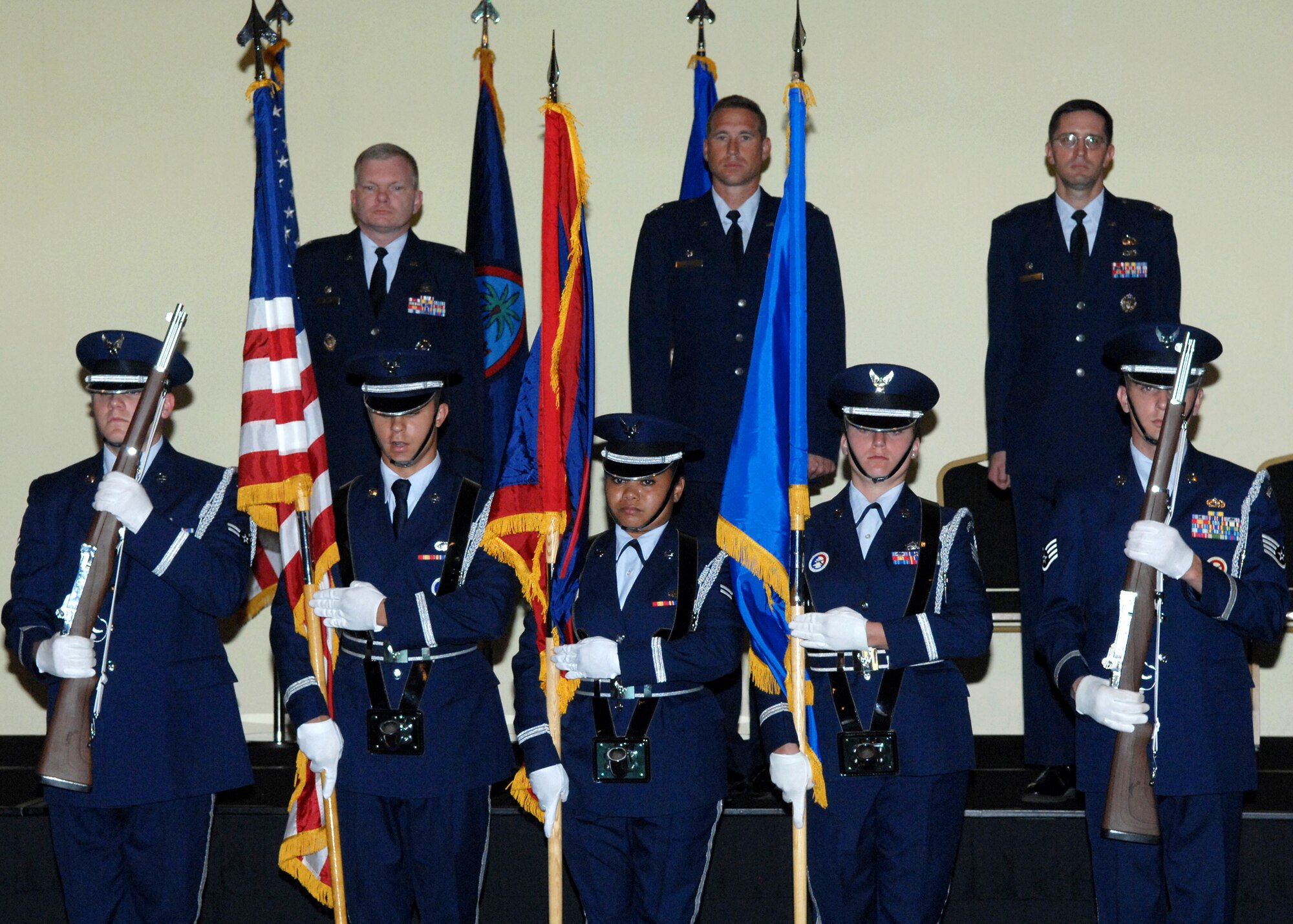 Col. Mark Talley 36th Mission Support Group commander, Lt. Col. Alex Gains and  Lt. Col. Paul Nosek stand for the posting of colors and singing of the national anthem, marking the beginning of the ceremony July 1 here. The 36th MSS and the 36th Services Squadron were deactivated and merged together creating a new squadron named the 36th Force Support Squadron.(U.S. Air Force by Airman 1st Class Nichelle Griffiths) 
