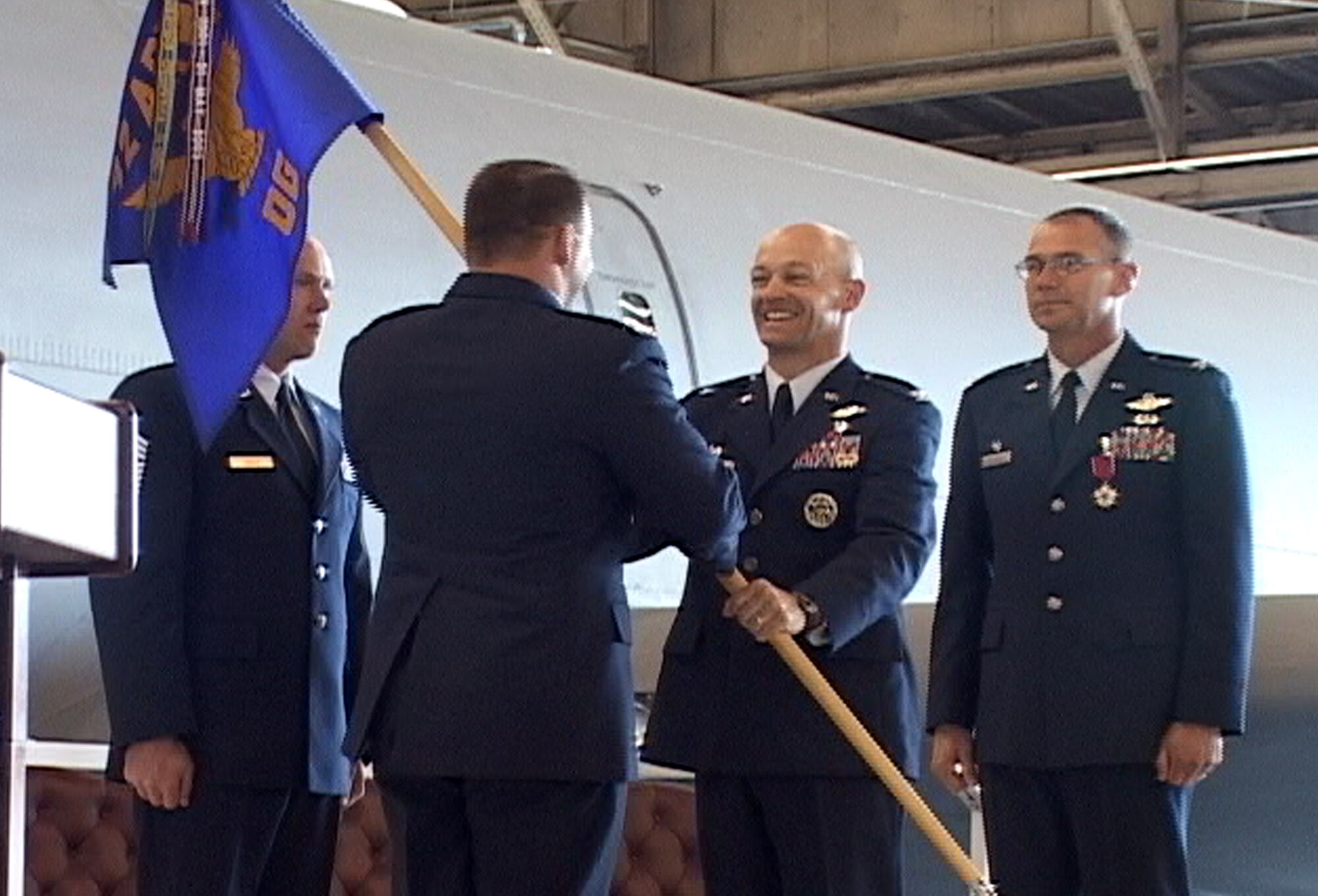 FAIRCHILD AIR FORCE BASE, Wash. – Col. Thomas Sharpy, 92nd Air Refueling Wing commander, presents Col. Marshall Morrison, 92nd Operations Group commander, with the group guideon during the 92nd OG change-of-command ceremony here June 27. Colonel Morrison was assigned to the Joint Staff, J8 Directorate, at the Pentagon, Washington D.C., prior to his arrival at Fairchild. (U.S. Air Force photo / Airman 1st Class Jesse James)