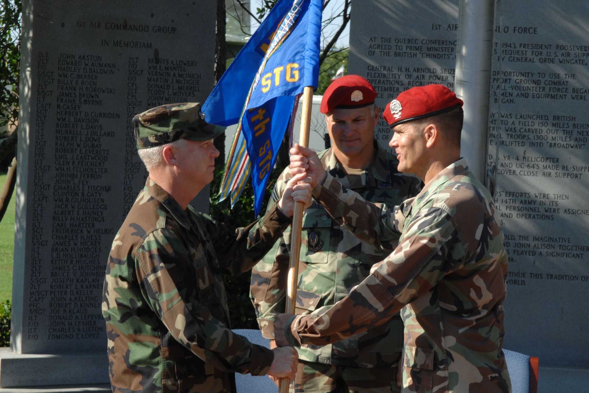 Col. Brad Thompson (right), new 720th Special Tactics Group commander, accepts the unit's flag from Lt. Gen. Donny Wurster (left), Air Force Special Operations Command commander, during the 720th STG change of command ceremony July 1 at Hurlburt Field. Col. Marc Stratton relinquished command of the Air Force's only special tactics squadron and leaves Hurlburt Field to become commander, U.S. Military Group, Chile, at the U.S. embassy in Santiago. (U.S. Air Force photo/Senior Airman Stephanie Jacobs)