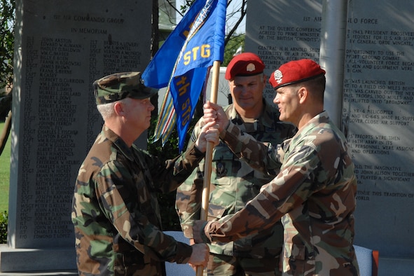 Col. Brad Thompson (right), new 720th Special Tactics Group commander, accepts the unit's flag from Lt. Gen. Donny Wurster (left), Air Force Special Operations Command commander, during the 720th STG change of command ceremony July 1 at Hurlburt Field. Col. Marc Stratton relinquished command of the Air Force's only special tactics squadron and leaves Hurlburt Field to become commander, U.S. Military Group, Chile, at the U.S. embassy in Santiago. (U.S. Air Force photo/Senior Airman Stephanie Jacobs)
