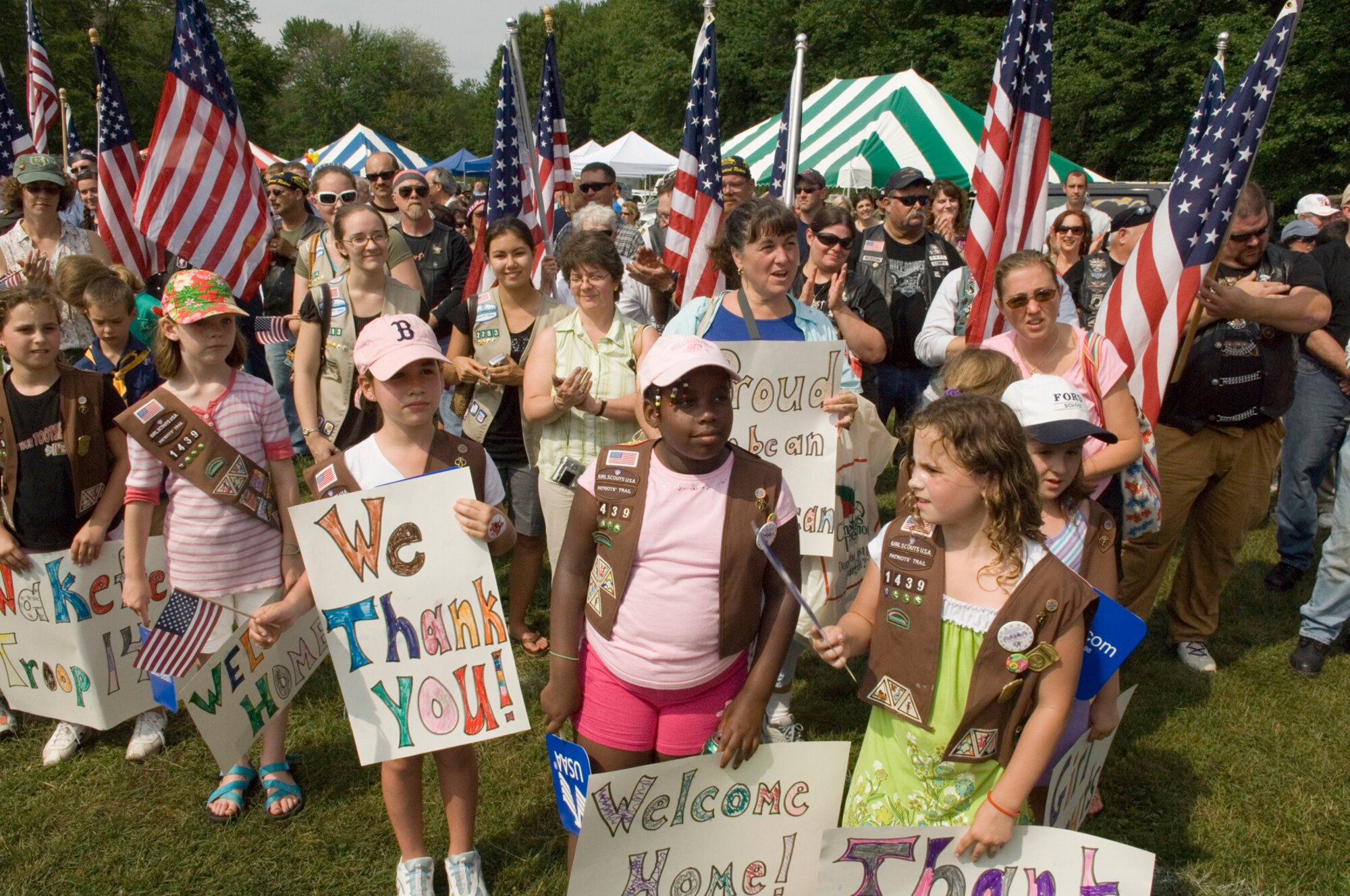 Girl Scouts from across eastern Massachusetts welcome home more than 50 base Airmen June 27 at Hanscom Air Force Base, Mass. The gathering was part of a Heroes' Homecoming celebration. Earlier this year, hundreds of Girl Scouts came to Hanscom AFB to deliver more than 10,000 boxes of Girl Scout cookies that were sent to deployed military members around the world. (U.S. Air Force photo/Rick Berry) 
