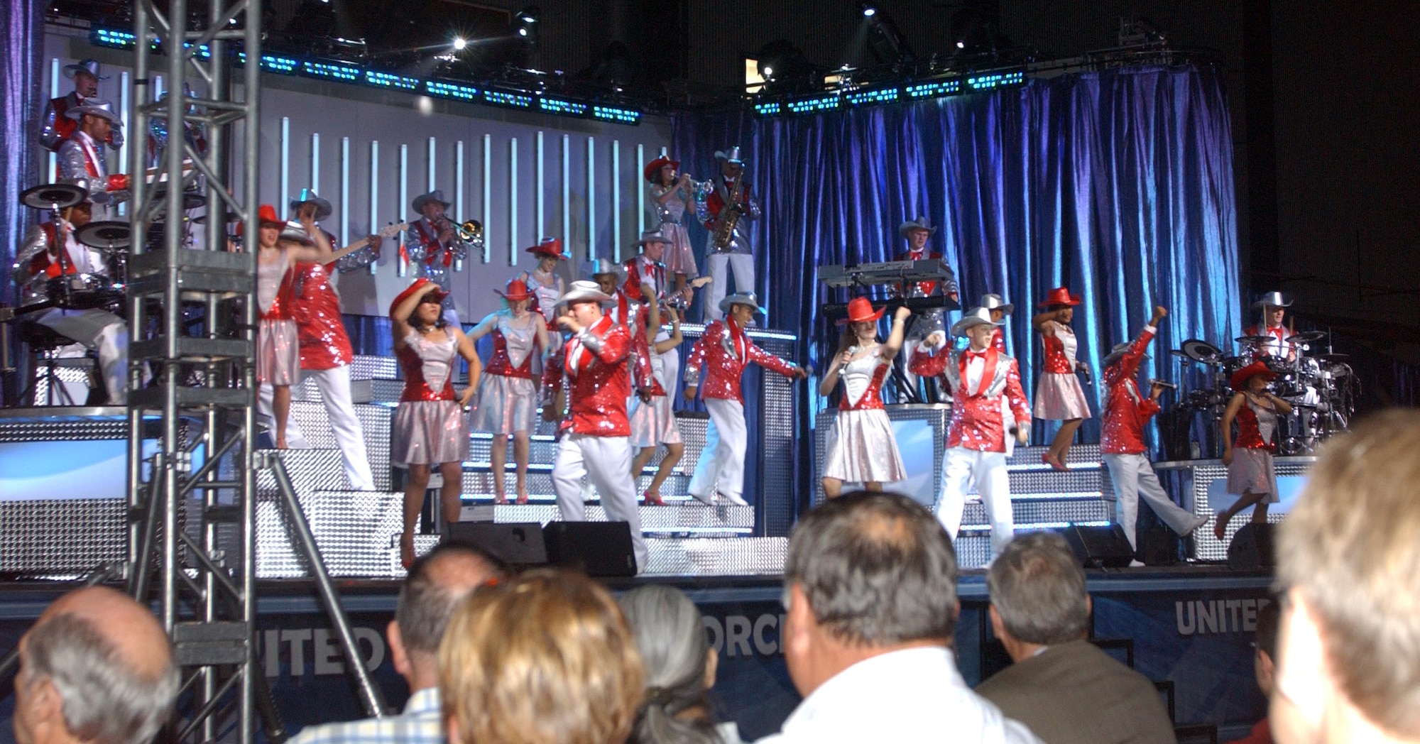 Tops in Blue belts out one of several country-western songs during their June 29 performance at the Chisholm Trail Expo Center in Enid, Okla. Tops in Blue is the U.S. Air Force's premier entertainment group and has been performing around the world for 55 years. (U.S. Air Force photo by Bob Farrell)   